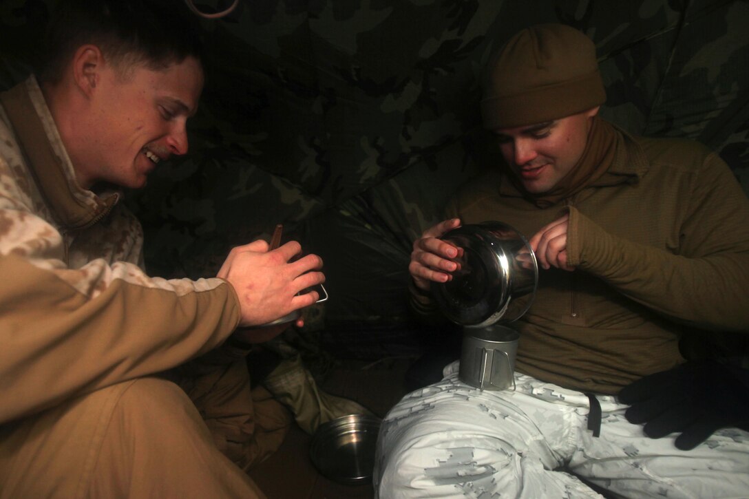 Cpl. Timothy J. Langendorfer share noodles with Cpl. Robert J. Schmitt after utilizing the water procurement skills they learned during cold weather training at Marine Corps Mountain Warfare Training Center, Calif., Jan. 21, 2016. The cold weather training done in the Sierra Mountains is a warm-up to Exercise Cold Response 1-16 in Norway. Nearly 80 Marines with 2nd LAAD Bn. participated in the two-weeklong exercise that taught basic mobility in snow, defensive and offensive tactics as well as basic cold weather and high altitude conditions training. Langendorfer and Schmitt are both low altitude air defense gunners with 2nd Low Altitude Air Defense Battalion.