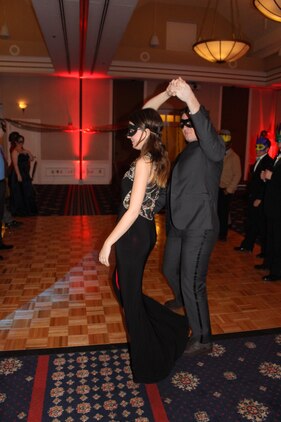 Lance Cpl. Kaleb Dillard, Combat Camera, dances with his date Kelley Heinss at the Mardi Gras Masquerade Ball on Jan. 29.