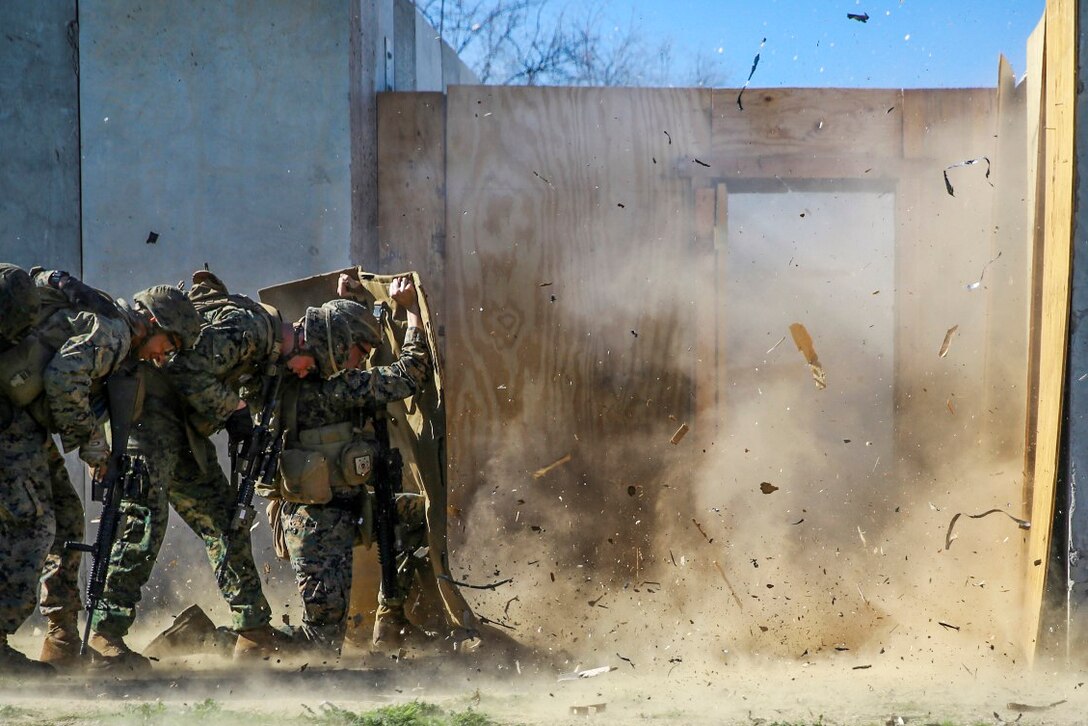 Marines shield themselves from a detonated explosive charge during an urban training course on Marine Corps Base Camp Pendleton, Calif., Jan. 29, 2016. During the course, Marines learned about four different types of charges. Marine Corps photo by Pvt. Robert Bliss