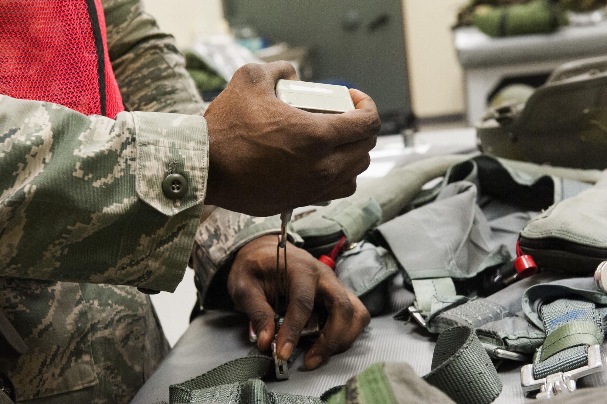Senior Airman Richmond Davis Jr., 8th Operation Support Squadron aircrew flight equipment journeyman, assembles a flight suit during Beverly Pack 16-2 at Kunsan Air Base, Republic of Korea, Feb. 4, 2015. Though the exercise was planned for months, Airmen were not told when it would start, testing their readiness and ability to respond to a crisis at a moment's notice. (U.S. Air Force photo by Staff Sgt. Nick Wilson/Released)