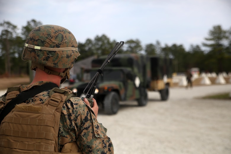 A Marine with 2nd Transportation Support Battalion radios the Command Operations Center as a vehicle enters the simulated Forward Operating Base Greater Sandy Runs Area during a tactical operations package with Battle Skills Training School, 2nd Marine Logistics Group, at Camp Lejeune, N.C., Feb. 3, 2016. The course is conducted to refresh Marines from non-infantry military occupational specialties on infantry-related skills and tactics in a five-week span. (U.S. Marine Corps photo by Cpl. Joey Mendez/Released)