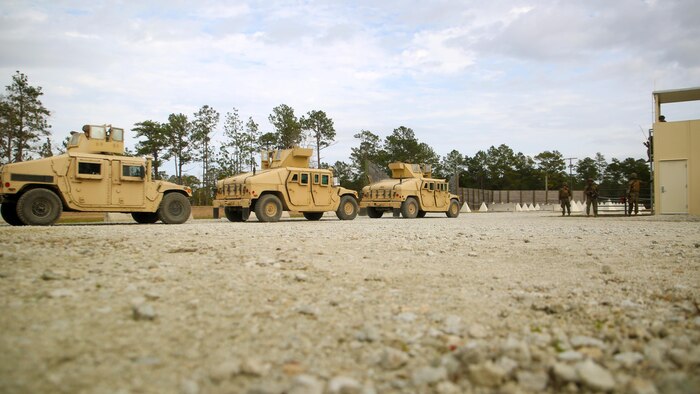 A vehicle convoy, operated by Marines with 2nd Transportation Support Battalion, prepares to exit the simulated Forward Operating Base Greater Sandy Runs Area to conduct counter-improvised explosive device training during a tactical operations package with Battle Skills Training School, 2nd Marine Logistics Group, at Camp Lejeune, N.C., Feb. 3, 2016. The course is conducted to refresh Marines from non-infantry military occupational specialties on infantry-related skills and tactics in a five-week span. (U.S. Marine Corps photo by Cpl. Joey Mendez/Released)