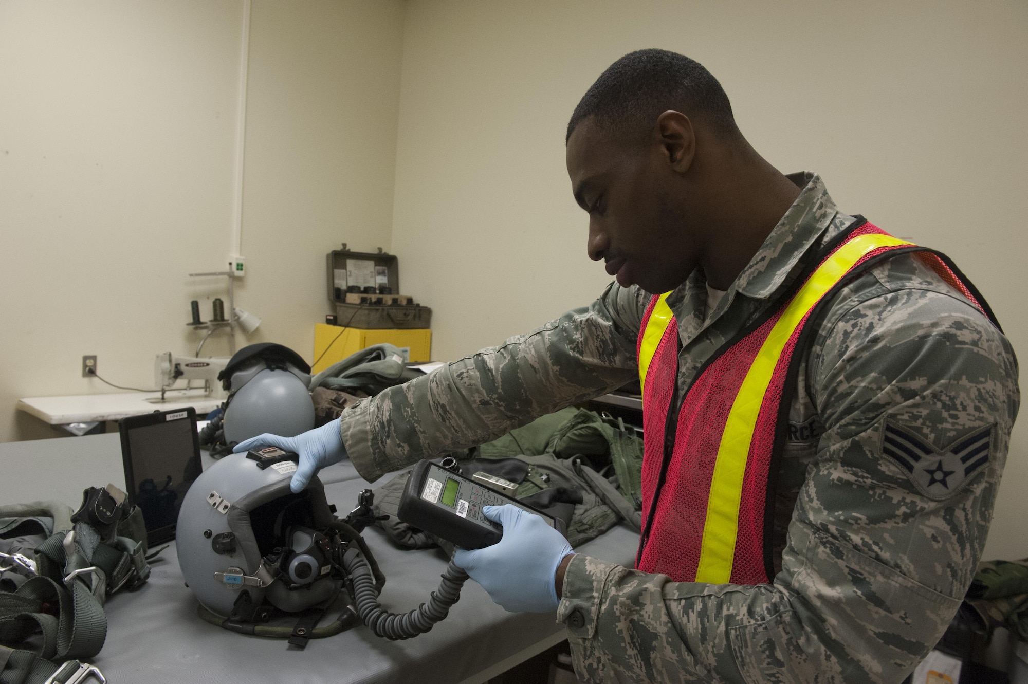 Senior Airman Richmond Davis Jr., 8th Operation Support Squadron aircrew flight equipment journeyman, tests an F-16 Fighting Falcon pilot’s helmet during Beverly Pack 16-2 at Kunsan Air Base, Republic of Korea, Feb. 4, 2015. The exercise tested Airmen on their ability to survive and operate while under the stress of simulated wartime activities. (U.S. Air Force photo by Staff Sgt. Nick Wilson/Released)
