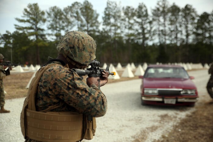 Marines with 2nd Transportation Support Battalion stop a vehicle as it enters the simulated Forward Operating Base Greater Sandy Runs Area during a tactical operations package with Battle Skills Training School, 2nd Marine Logistics Group, at Camp Lejeune, N.C., Feb. 3, 2016. The course is conducted to refresh Marines from non-infantry military occupational specialties on infantry-related skills and tactics in a five-week span. (U.S. Marine Corps photo by Cpl. Joey Mendez/Released)