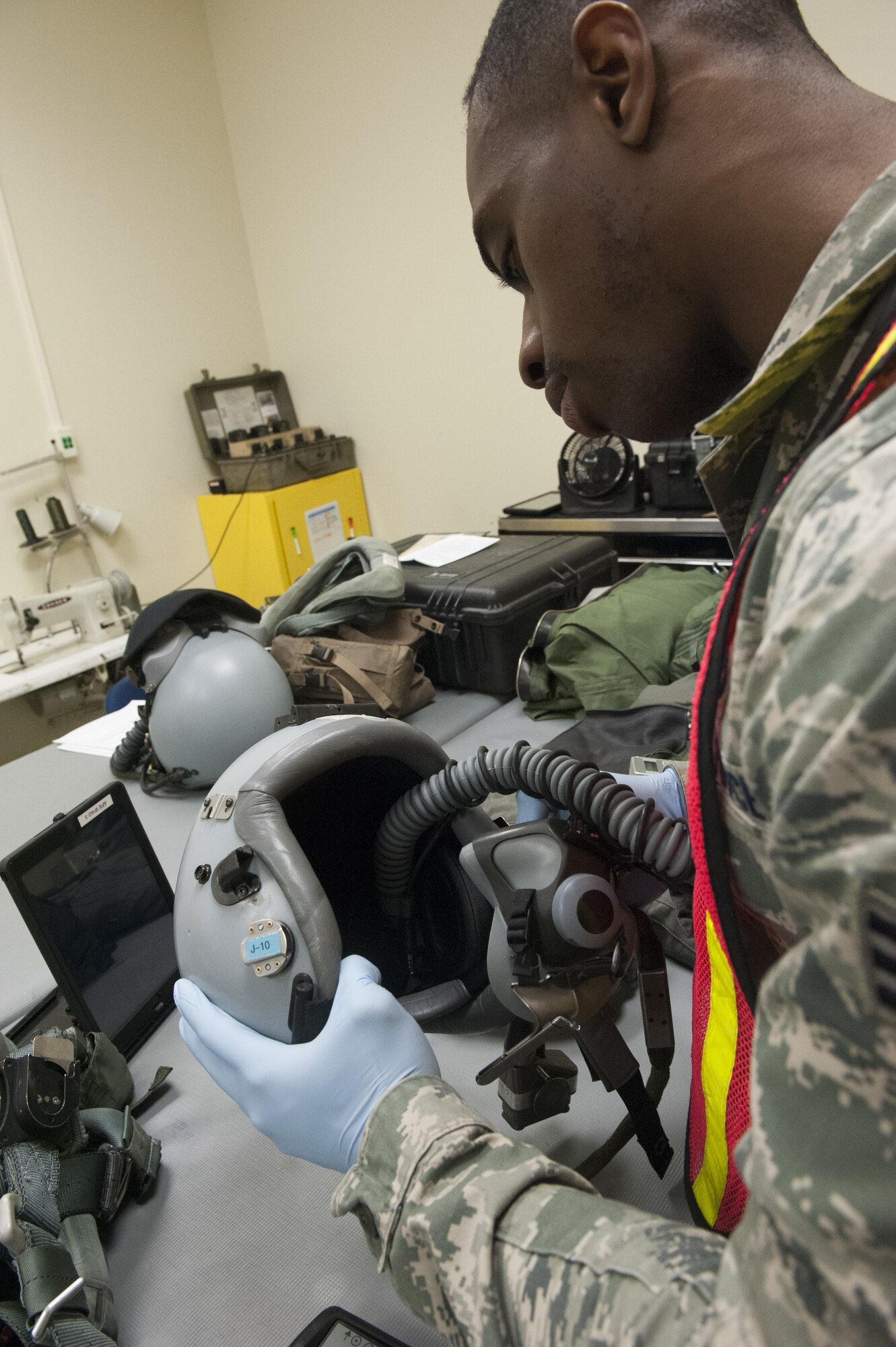 Senior Airman Richmond Davis Jr., 8th Operation Support Squadron aircrew flight equipment journeyman, tests an F-16 Fighting Falcon pilot’s helmet during Beverly Pack 16-2 at Kunsan Air Base, Republic of Korea, Feb. 4, 2015. Though the exercise was planned for months, Airmen were not told when it would start, testing their readiness and ability to respond to a crisis at a moment's notice. (U.S. Air Force photo by Staff Sgt. Nick Wilson/Released)