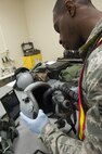 Senior Airman Richmond Davis Jr., 8th Operation Support Squadron aircrew flight equipment journeyman, tests an F-16 Fighting Falcon pilot’s helmet during Beverly Pack 16-2 at Kunsan Air Base, Republic of Korea, Feb. 4, 2015. Though the exercise was planned for months, Airmen were not told when it would start, testing their readiness and ability to respond to a crisis at a moment's notice. (U.S. Air Force photo by Staff Sgt. Nick Wilson/Released)