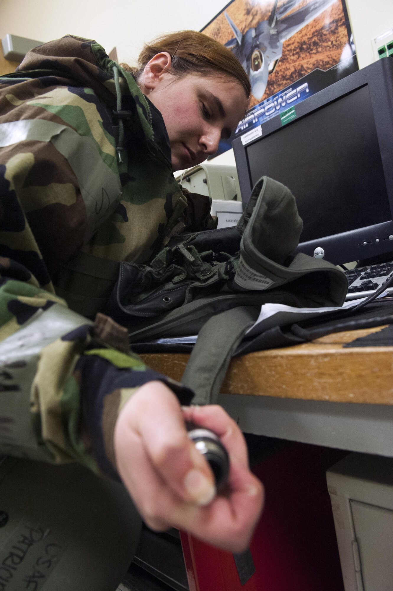 Staff Sgt. Patricia Johnson, 8th Operation Support Squadron aircrew flight equipment journeyman, tests the air pressure of an F-16 Fighting Falcon pilot’s G-suit during Beverly Pack 16-2 at Kunsan Air Base, Republic of Korea, Feb. 4, 2015. Though the exercise was planned for months, Airmen were not told when it would start, testing their readiness and ability to respond to a crisis at a moment's notice. (U.S. Air Force photo by Staff Sgt. Nick Wilson/Released)