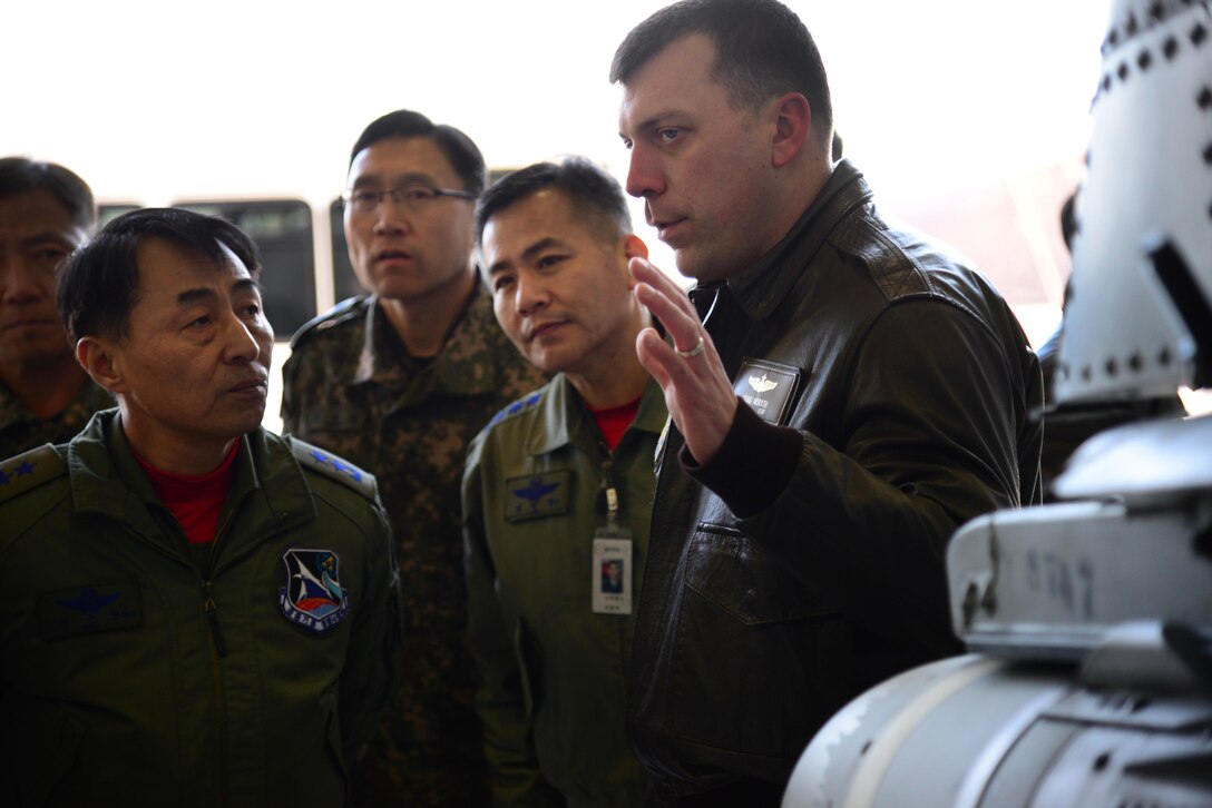 Maj. Craig Morash, 25th Fighter Squadron director of operations, briefs Maj. Gen. Choi, Geyn Young, Republic of Korea air force Air Mobility Reconnaissance Command commander, on A-10 Thunderbolt II capabilities during an immersion tour at Osan Air Base, ROK, Feb. 1, 2016. Choi toured the base to learn about the various assets the 51st Fighter Wing provides. (U.S. Air Force photo by Staff Sgt. Amber Grimm/Released)