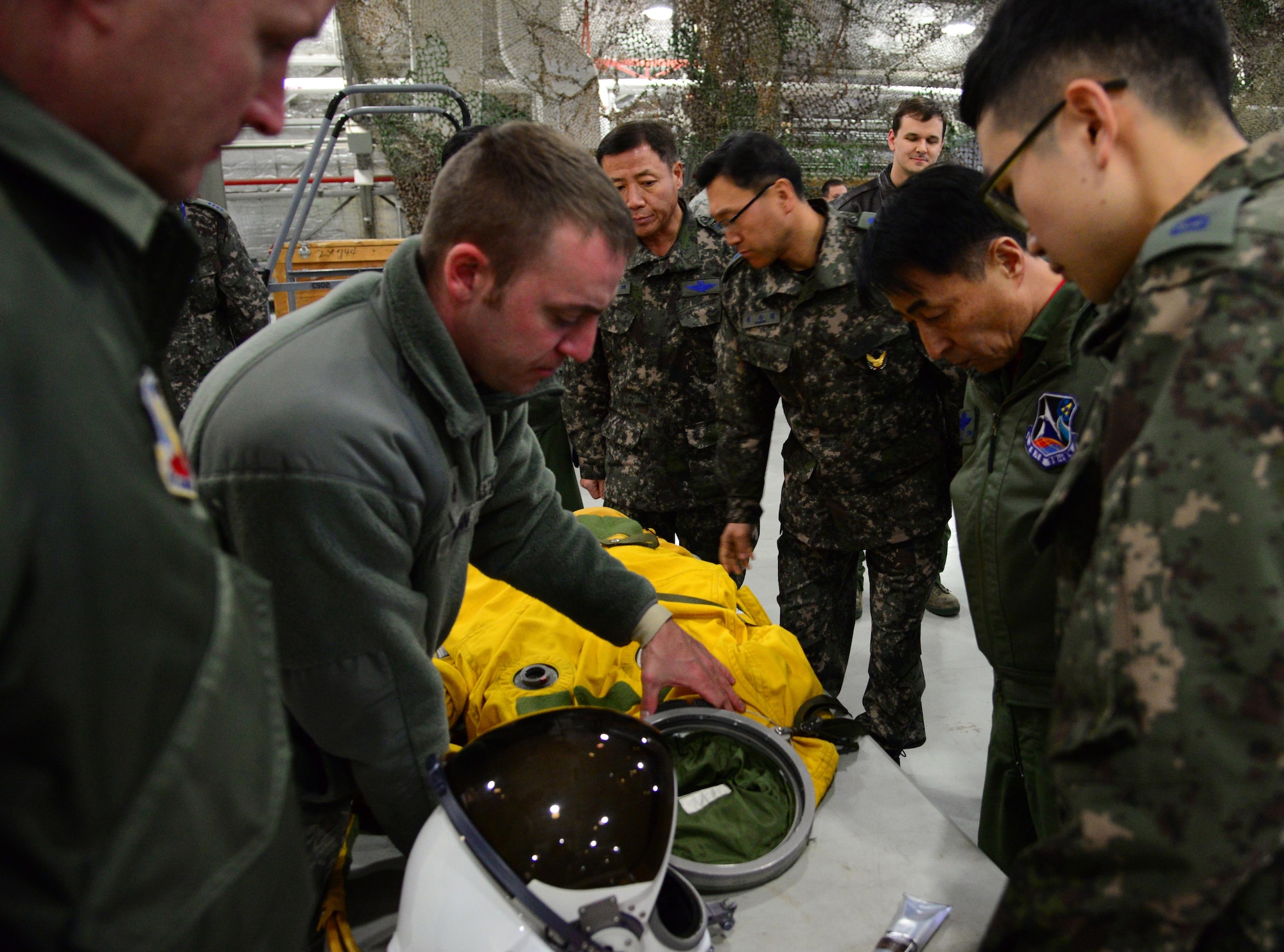 Senior Airman Johnathon Jordan, 5th Reconnaissance Squadron physiological support technician, explains the suit worn by U-2 pilots to Maj. Gen. Choi, Geyn Young, Republic of Korea air force Air Mobility Reconnaissance Command commander, at Osan Air Base, ROK, Feb. 1, 2016. During his immersion tour, Choi was briefed on the mission and capabilities of the F-16 Fighting Falcon, A-10 Thunderbolt II and U-2 Dragon Lady. (U.S. Air Force photo by Staff Sgt. Amber Grimm/Released)
