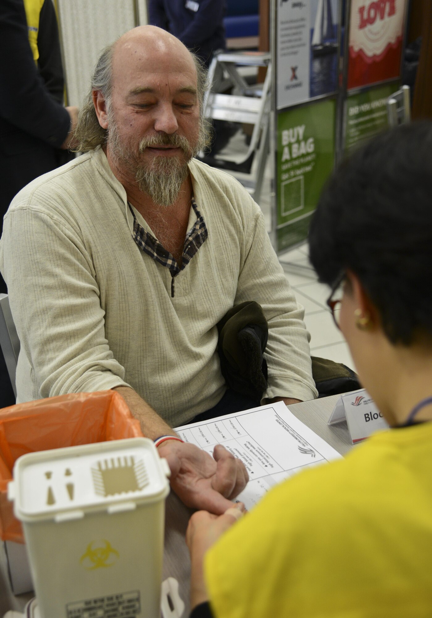 Retired Tech. Sgt. Jeff Laman, receives a blood-sugar test from a Hallym University Dongtan Sacred Heart Hospital nurse during the Retiree Appreciation Day in the Exchange at Osan Air Base, Republic of Korea, Feb. 4, 2016. Laman was one of many retirees who received some extra care, attention and appreciation during the Exchange-sponsored event. (U.S. Air Force photo by Tech. Sgt. Travis Edwards/Released)