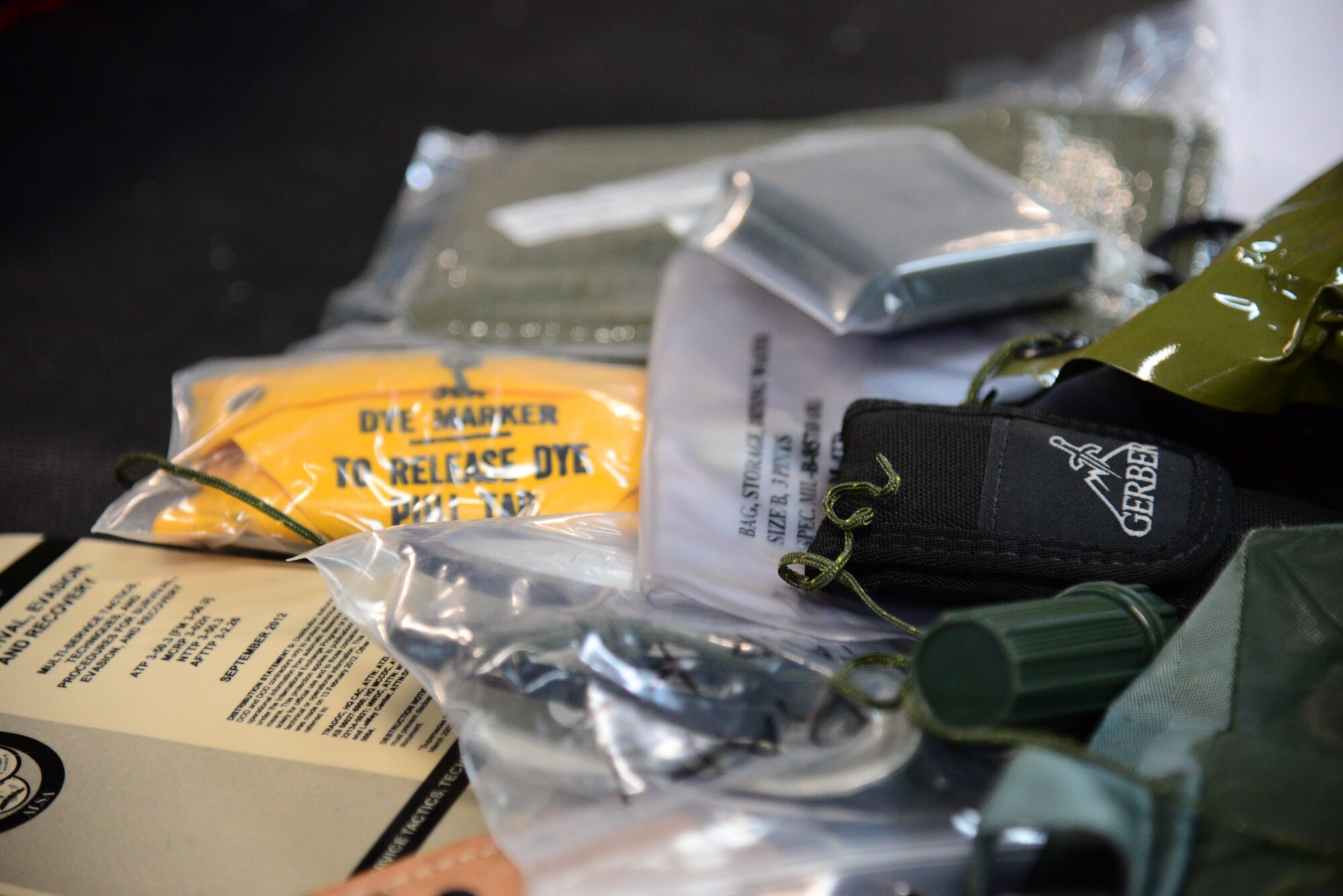 Components of a pilot’s survival kit are laid out for inspections before being packed away in the main shop of the 51st Operations Support Squadron Aircrew Flight Equipment shop at Osan Air Base, Republic of Korea, Jan. 26, 2016.  The main shop is responsible for maintaining all equipment installed in each aircrafts ejection seats. (U.S. Air Force photo by Staff Sgt. Amber Grimm/Released)