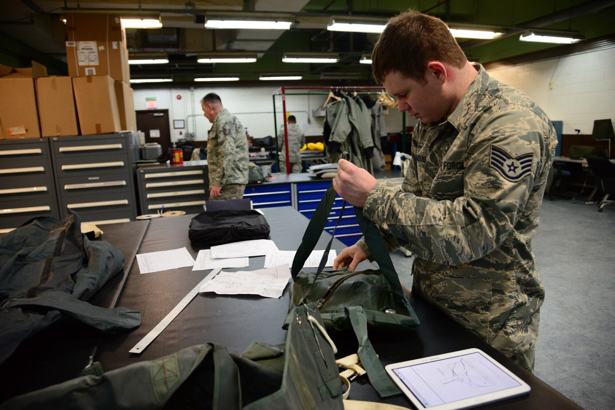 Staff Sgt. Ryan Malmquist, 51st Operations Support Squadron aircrew flight equipment specialist, repacks a pilot survival kit at the AFE main shop on Osan Air Base, Republic of Korea, Jan. 26, 2016. The main shop is responsible for maintaining all equipment installed in each aircrafts ejection seats. (U.S. Air Force photo by Staff Sgt. Amber Grimm/Released)