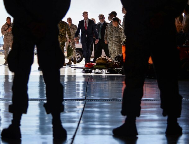Defense Secretary Ash Carter enters the 823rd Maintenance Squadron hangar to meet with a group of Airmen at Nellis Air Force Base, Nev., Feb. 4, 2016. The defense secretary spoke to Airmen about attaining a lasting defeat of the Islamic State of Iraq and the Levant, while also ensuring the department is ready for potential conflict with higher-end adversaries and more technologically-advanced threats in the future. (U.S. Air Force photo by Airman 1st Class Kevin J. Tanenbaum)