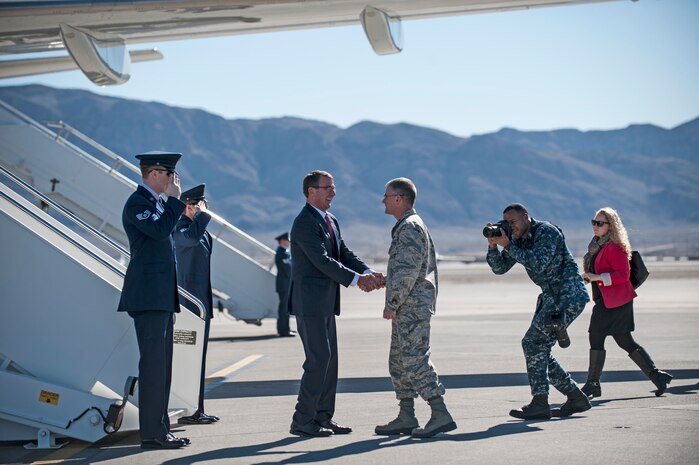 Defense Secretary Ash Carter is greeted by Maj. Gen. Jay Silveria, U.S. Air Force Warfare Center commander, upon his arrival to Nellis Air Force Base, Nev., Feb. 4, 2016. Carter’s visit consisted of briefings and meetings with Airmen focused on readiness; and comes a week before President Barack Obama will release his administration’s 2017 defense budget. (U.S. Air Force photo by Senior Airman Joshua Kleinholz)