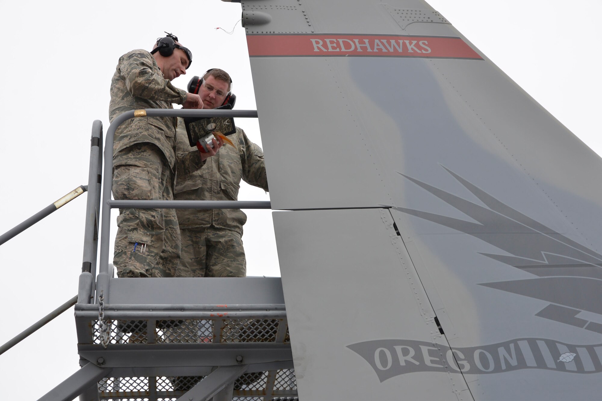 From the 142nd Fighter Wing, Portland, Oregon, Staff Sgt. Aaron Lamb, (left),  142nd Maintenance Group electrical-environmental systems craftsman, reviews technical data with Master Sgt. Russ Stevens, an F-15 Eagle crew chief, Jan. 28 as they prepare to replace a vertical-right-stabilizer light during a deployment to Combat Archer, a two-week weapon systems evaluation program at Tyndall Air Force Base. During the program, participants load, fly and shoot live missiles and subsequently evaluate the entire process to validate whether the weapon performs according to established specifications. (Air Force Photo Released/Mary McHale)