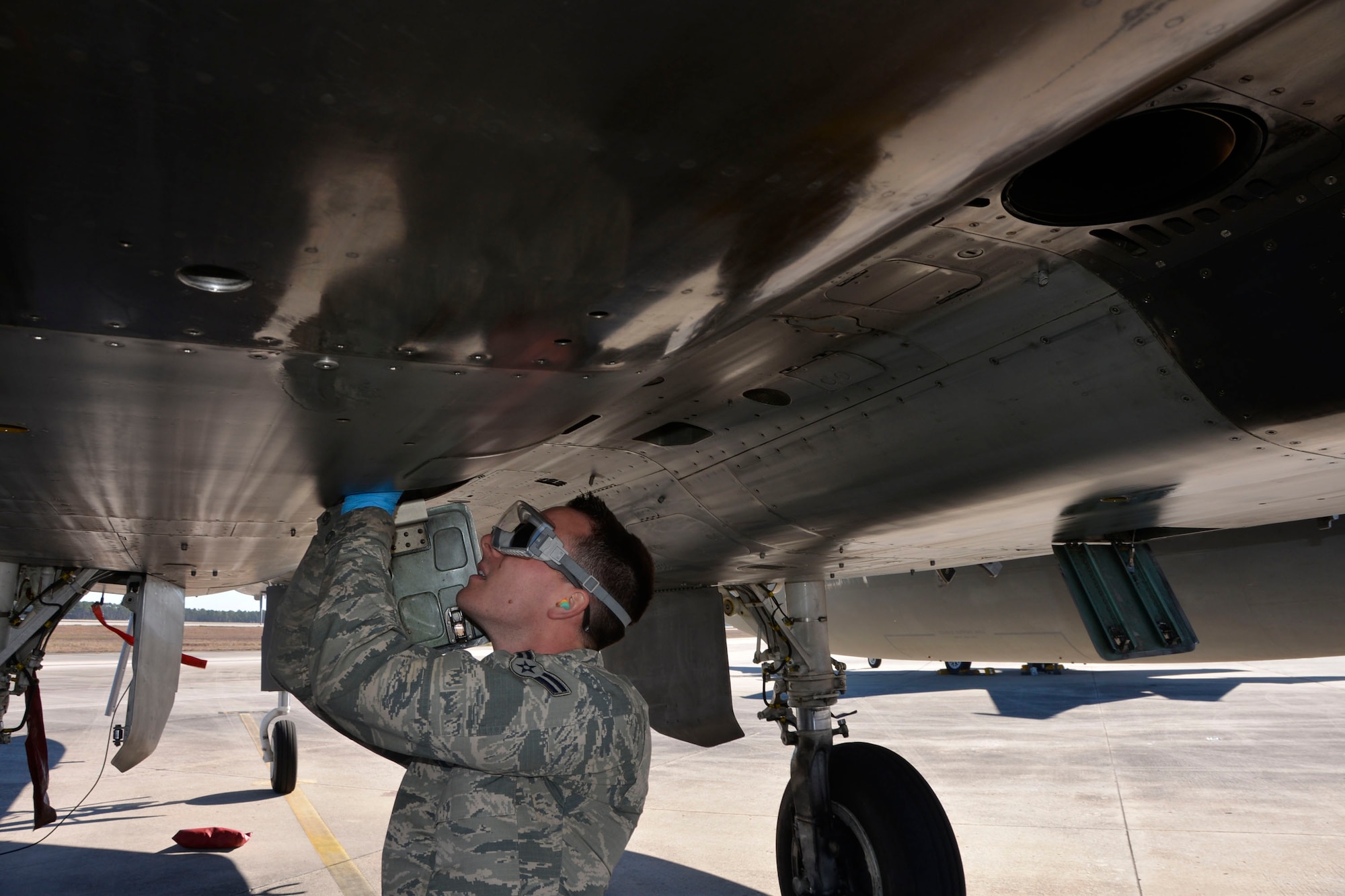 From the 142nd Fighter Wing, Portland, Oregon, Airman 1st Class Brian Perkins, 142nd Maintenance Group F-15 crew chief, takes an oil sample following a Combat Archer sortie at Tyndall AFB, Florida, Jan. 29. Combat Archer is a two-week weapon systems evaluation program where participants load, fly and shoot live missiles and subsequently evaluate the entire process to validate whether the weapon performs according to established specifications. (Air Force Photo Released/Mary McHale)