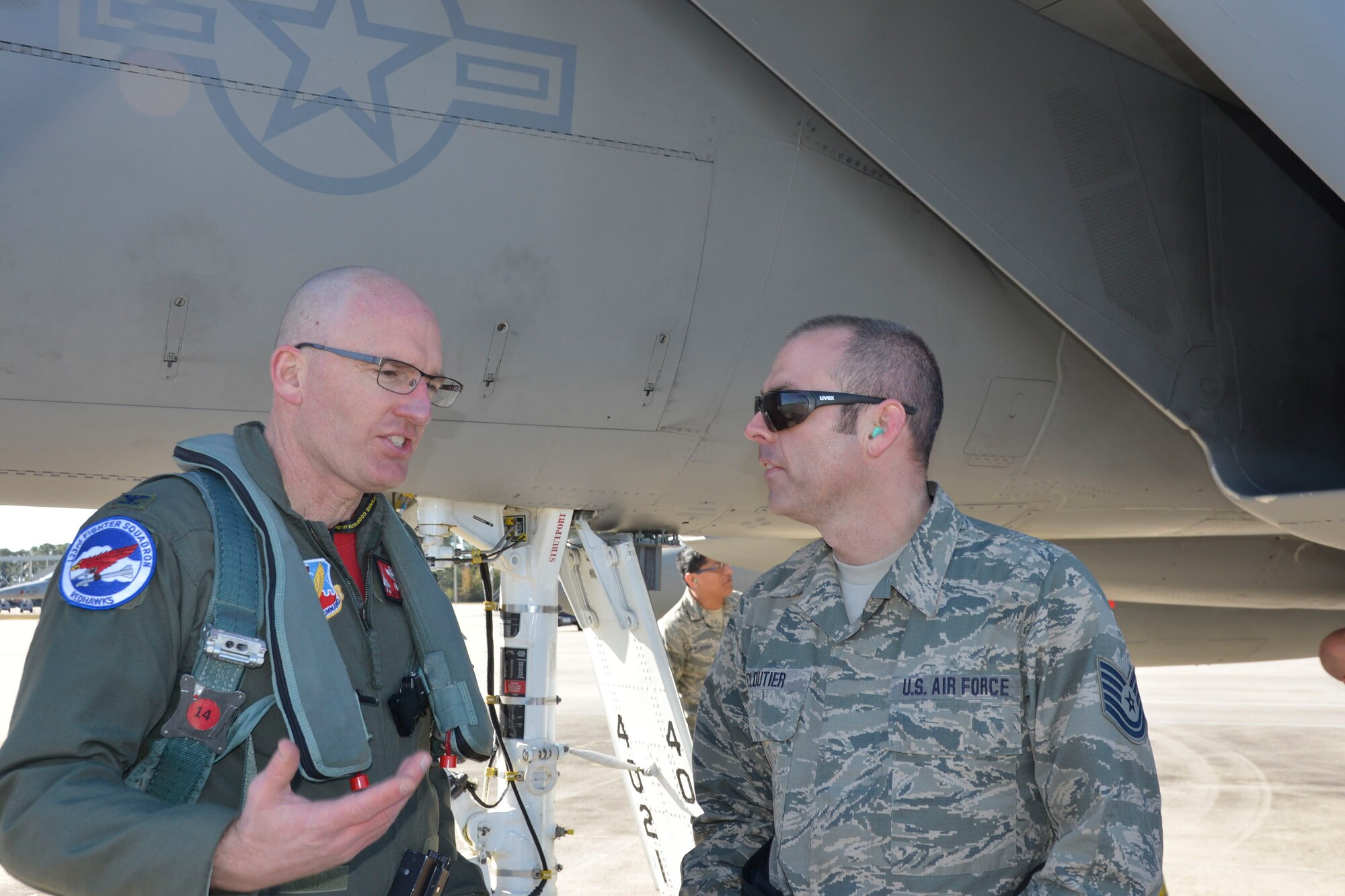 From the 142nd Fighter Wing, Portland, Oregon, Col. Paul Fitzgerald, wing commander and F-15 Eagle pilot, talks with Tech. Sgt. John Cloutier, F-15 crew chief, on the flightline at Tyndall Air Force Base, following a Combat Archer sortie Jan. 29. Combat Archer is a two-week weapon systems evaluation program where participants load, fly and shoot live missiles and subsequently evaluate the entire process to validate whether the weapon performs according to established specifications. (Air Force Photo Released/Mary McHale)