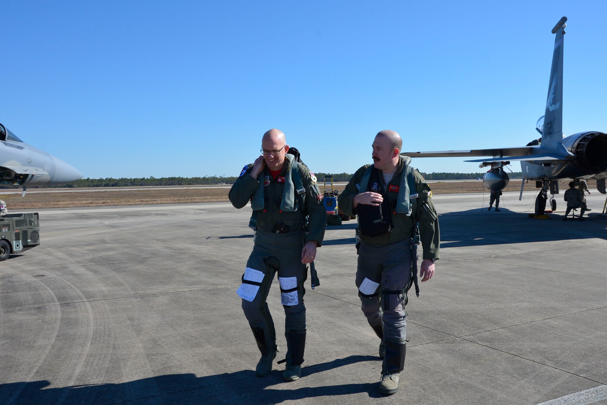 From the 142nd Fighter Wing, Portland Oregon, Col. Paul Fitzgerald, wing commander and F-15 Eagle pilot, (left) walks with fellow pilot, Maj. Vic Knill, 123rd Fighter Squadron, following a Combat Archer sortie at Tyndall Air Force Base Jan. 29. Combat Archer is a two-week weapon systems evaluation program where participants load, fly and shoot live missiles and subsequently evaluate the entire process to validate whether the weapon performs according to established specifications. (Air Force Photo Released/Mary McHale)