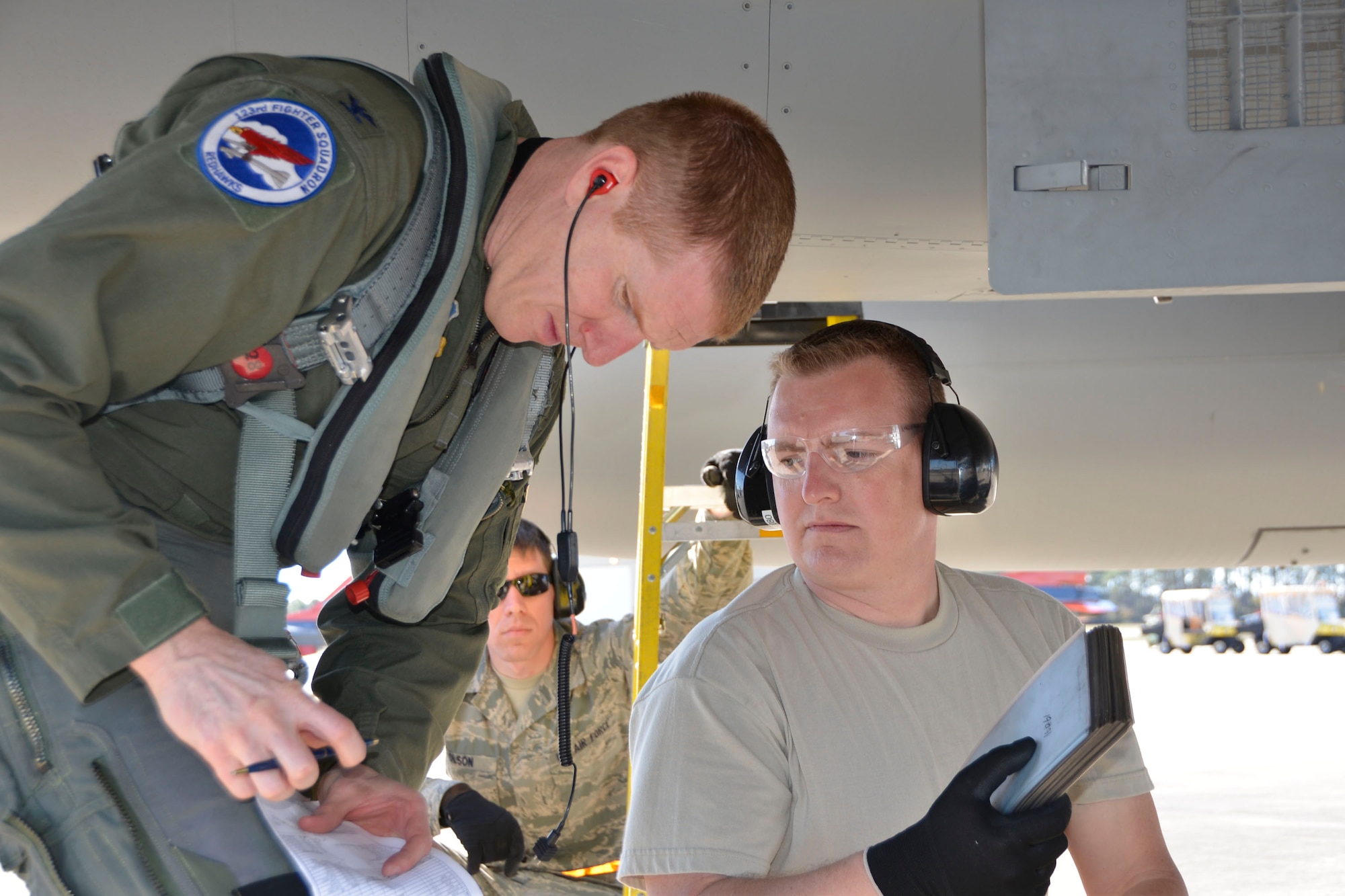 From the 142nd Fighter Wing, Portland, Oregon, Col Adam Sitler, 142nd Operations Group Commander and F-15 Eagle pilot, confers with Master Sgt.  Robert Harsh, 142nd Maintenance Group weapons loader, about mission data following a Combat Archer sortie at Tyndall Air Force Base Jan. 28. Combat Archer is a two-week weapon systems evaluation program where participants load, fly and shoot live missiles and subsequently evaluate the entire process to validate whether the weapon performs according to established specifications. (Air Force Photo Released/Mary McHale)
