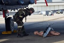 Staff Sgt. Derek Horn, 4th Civil Engineer Squadron explosive ordnance disposal technician, attempts to identify a simulated weapon during exercise Coronet Warrior 16-01, Feb. 1, 2016, at Seymour Johnson Air Force Base, North Carolina. After a simulated bomb was dropped, EOD members were called out to the flightline to determine how to safely remove the explosive and clear the scene. (U.S. Air Force photo/Airman Shawna L. Keyes)