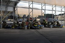Airmen from the 4th Aircraft Maintenance Squadron huddle inside a simulated bunker during exercise Coronet Warrior 16-01, Feb. 1, 2016, at Seymour Johnson Air Force Base, North Carolina. Airmen working on the flightline donned mission oriented protective posture gear and conducted various simulations during the exercise. (U.S. Air Force photo/Airman Shawna L. Keyes)   
