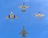 A U.S. Air Force F-16 Fighting Falcon (bottom) joins in formation with a P-40 Warhawk (top), P-51 Mustang (right), and a F-86 Sabre Jet (left) over Davis-Monthan Air Force Base, Ariz., during Heritage Flight Training Course March 2, 2014. During the course aircrews practiced ground and flight training to allow civilian pilots of historic military aircraft and current Air Force fighter pilots to safely fly in formations together, in preparation for the upcoming Open House. (U.S. Air Force photo by Airman 1st Class Chris Massey/ Released) 