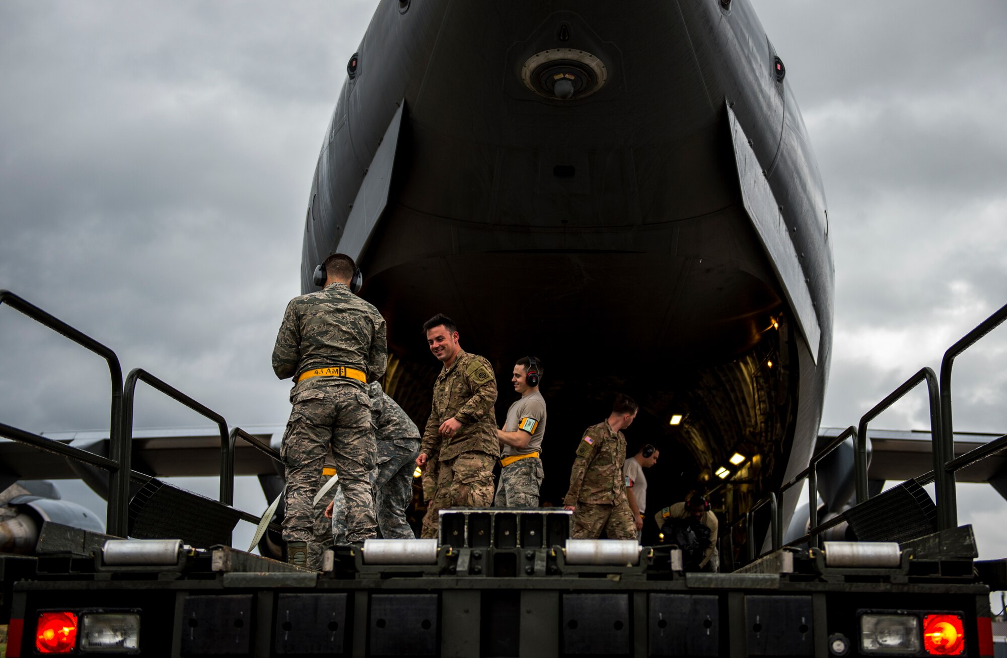 U.S. Air Force loadmasters and joint airdrop inspectors discuss inspection processes during Large Package Week at Pope Army Airfield, N.C., Feb. 3, 2016. Large Package Week leads up to Joint Access Exercise 16-5, wherein Army and Air Force units work together to improve interoperability for worldwide crisis, contingency and humanitarian operations. (U.S. Air Force photo by Staff Sgt. Marianique Santos)

