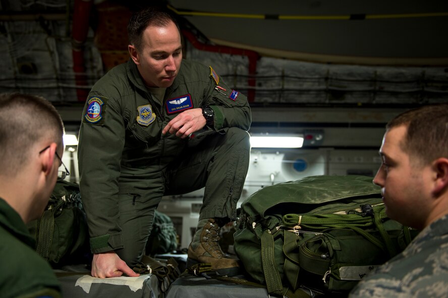 U.S. Air Force loadmasters and joint airdrop inspectors discuss inspection processes during Large Package Week at Pope Army Airfield, N.C., Feb. 3, 2016. Large Package Week leads up to Joint Access Exercise 16-5, wherein Army and Air Force units work together to improve interoperability for worldwide crisis, contingency and humanitarian operations. (U.S. Air Force photo by Staff Sgt. Marianique Santos)
