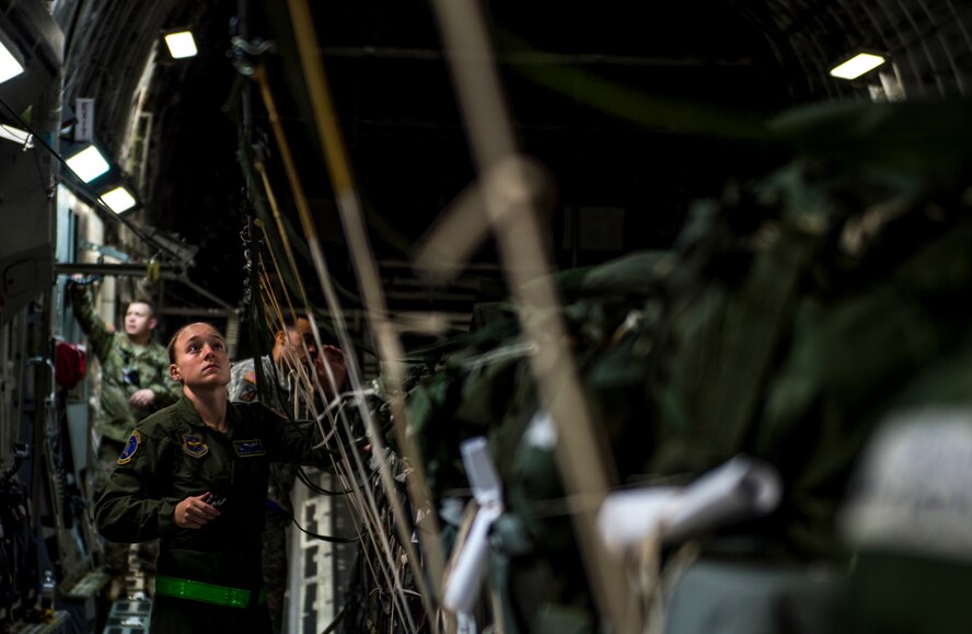 U.S. Air Force loadmasters and joint airdrop inspectors discuss inspection processes during Large Package Week at Pope Army Airfield, N.C., Feb. 3, 2016. Large Package Week leads up to Joint Access Exercise 16-5, wherein Army and Air Force units work together to improve interoperability for worldwide crisis, contingency and humanitarian operations. (U.S. Air Force photo by Staff Sgt. Marianique Santos)

