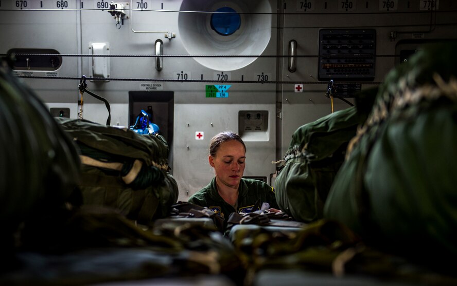 U.S. Air Force Staff Sgt. Brittany Canzoneri, 43rd Operations Support Squadron loadmaster and joint airdrop inspector, inspect static lines connected to container delivery system bundles during Large Package Week at Pope Army Airfield, N.C., Feb. 3, 2016. Large Package Week leads up to Joint Access Exercise 16-5, where in Army and Air Force units work together to improve interoperability for worldwide crisis, contingency and humanitarian operations. (U.S. Air Force photo by Staff Sgt. Marianique Santos) 