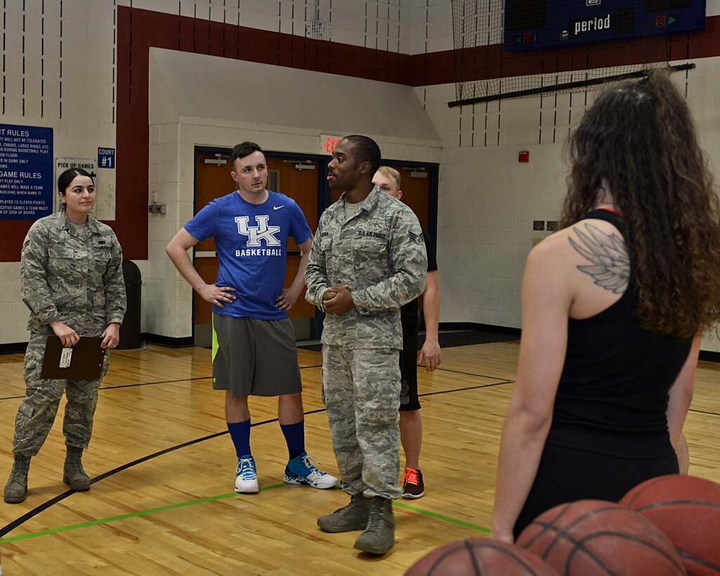 Senior Airman Denzel Adams, 28th Force Support Squadron fitness specialist, explains the rules of a basketball free-throw competition to participants inside the Bellamy Fitness Center at Ellsworth Air Force Base, S.D., Jan. 27, 2016. The goal of the competition was to help foster morale while encouraging physical activity amongst Ellsworth Airmen. (U.S. Air Force photo by Airman Sadie Colbert/Released)