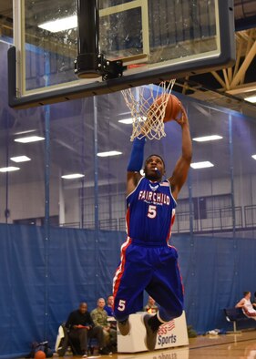 Airman 1st Class Alex Myer, 92nd Maintenance Squadron aircraft maintenance journeyman, makes a slam dunk for the slam dunk contest during the first All-Star Basketball game Feb. 3, 2016, at Fairchild Air Force Base, Wash. Four players participated and were scored based on the quality of the slam dunk. (U.S. Air Force photo/Airman 1st Class Taylor Bourgeous) 
