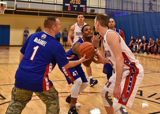 Col. Brian McDaniel, 92nd Air Refueling Wing commander, sets up the ball for Airman 1st Class Andre Davis, 92nd Force Support Squadron services apprentice, and Staff Sgt. Joshua Sipos, 66th Training Squadron survival, evasion, resistance and escape technical training instructor, for the honorary jump ball during the first All-Star Basketball game Feb. 3, 2016, at Fairchild Air Force Base, Wash. There will also be an All-Star game for each sport at the end of each intramural season. (U.S. Air Force photo/Airman 1st Class Taylor Bourgeous) 
