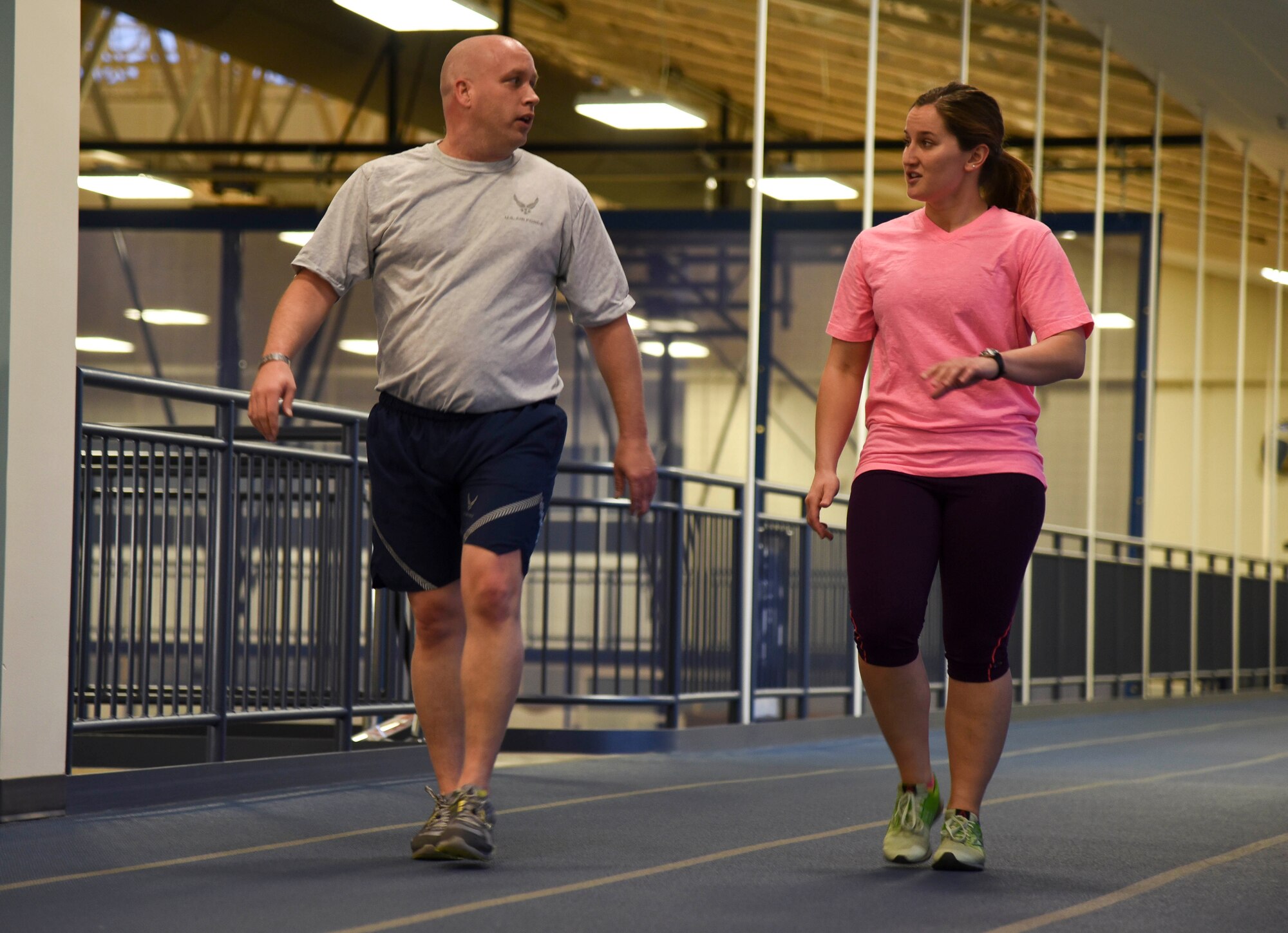 Airman 1st Class Kristina Kovch, 92nd Medical Operations Squadron aerospace medical technician, paces Master Sgt. Mike Lewandowski, 92nd MDOS medical information systems flight chief, during the run clinic program. Kovch was one of NBC's American Ninja Warrior competitors and is now helping Airmen improve on their physical fitness test. (U.S. Air Force photo/ Senior Airman Janelle Patiño)