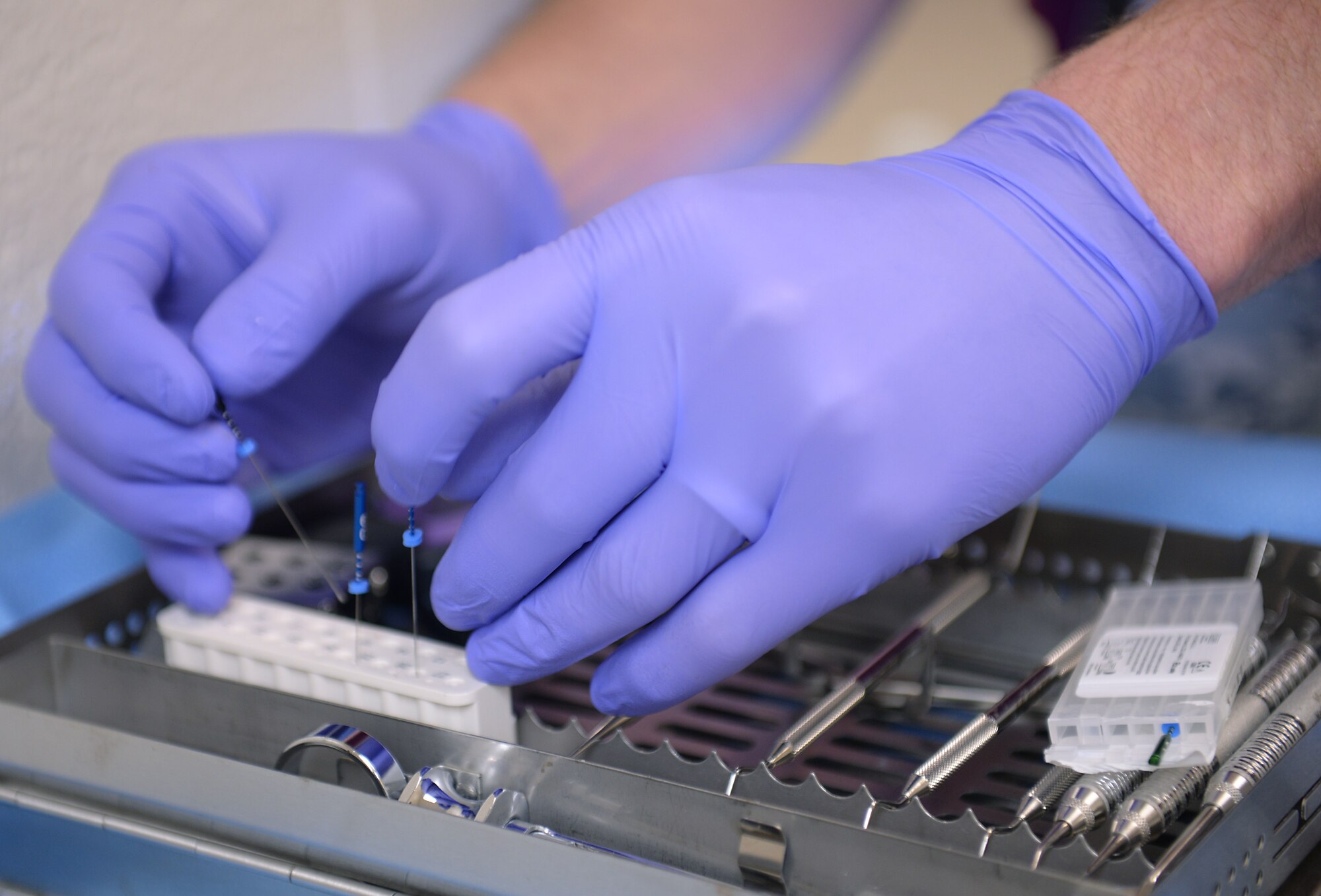 U.S. Air Force Maj. Scott Seago, endodontics chief assigned to the 633rd Dental Squadron, pulls out the necessary tools to perform a root canal on a 633rd Security Forces Squadron military working dog at the veterinary clinic at Langley Air Force Base, Va., Jan. 27, 2016. The average length of the root of a dog’s tooth is between three and five times the length of a human’s; therefore, the dental clinic had to order special equipment for the procedure. (U.S. Air Force photo by Staff Sgt. Teresa J. Cleveland)