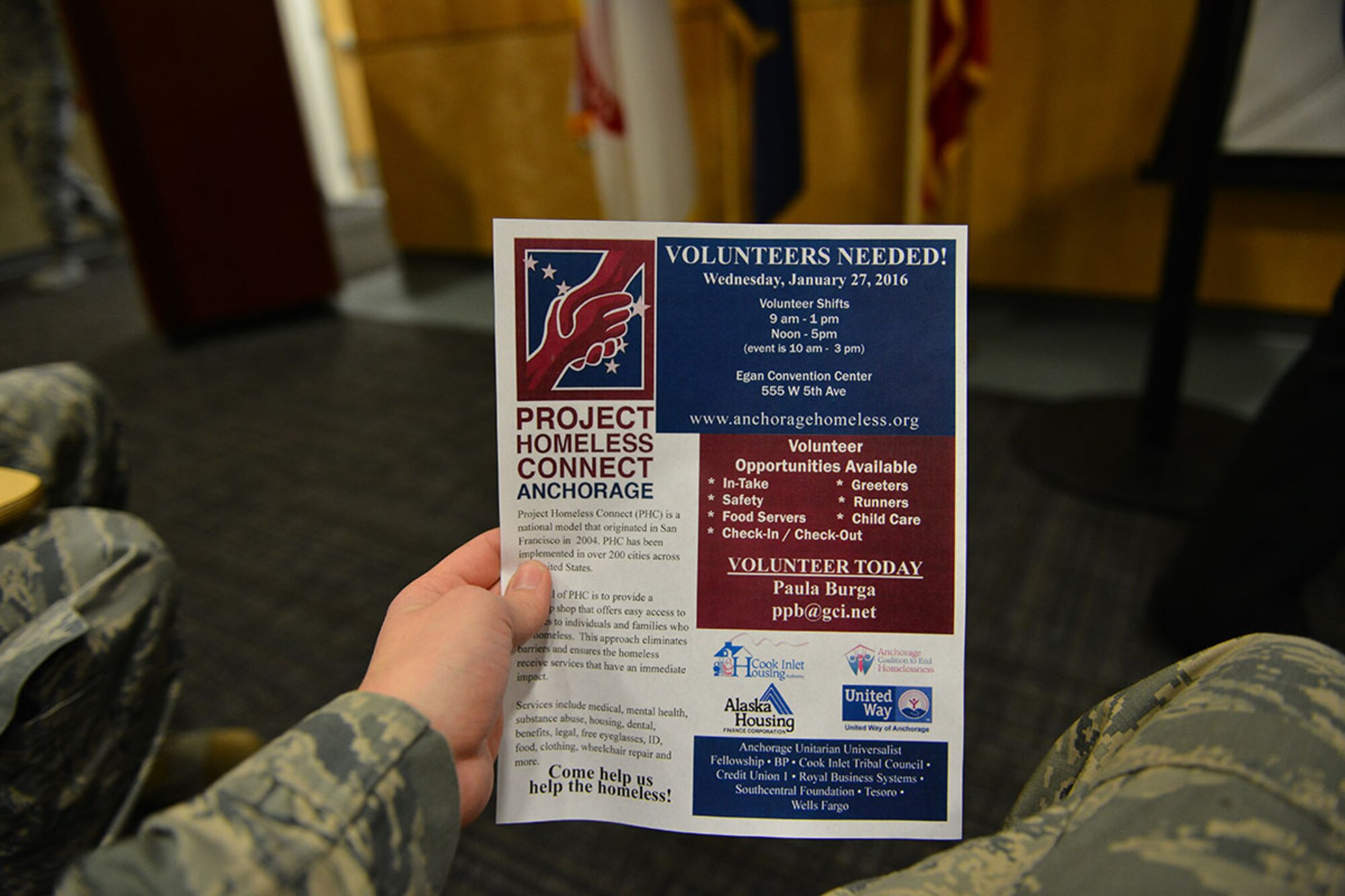 An Airman examines a flyer requesting volunteers for the Project Homeless Connect survey Jan 21. The survey was conducted Jan. 27. More than 80 service members from Joint Base Elmendorf-Richardson, Alaska volunteered, accounting for more than two-thirds of the total volunteers for the survey. (U.S. Air Force photo by Airman 1st Class Kyle Johnson/Released)