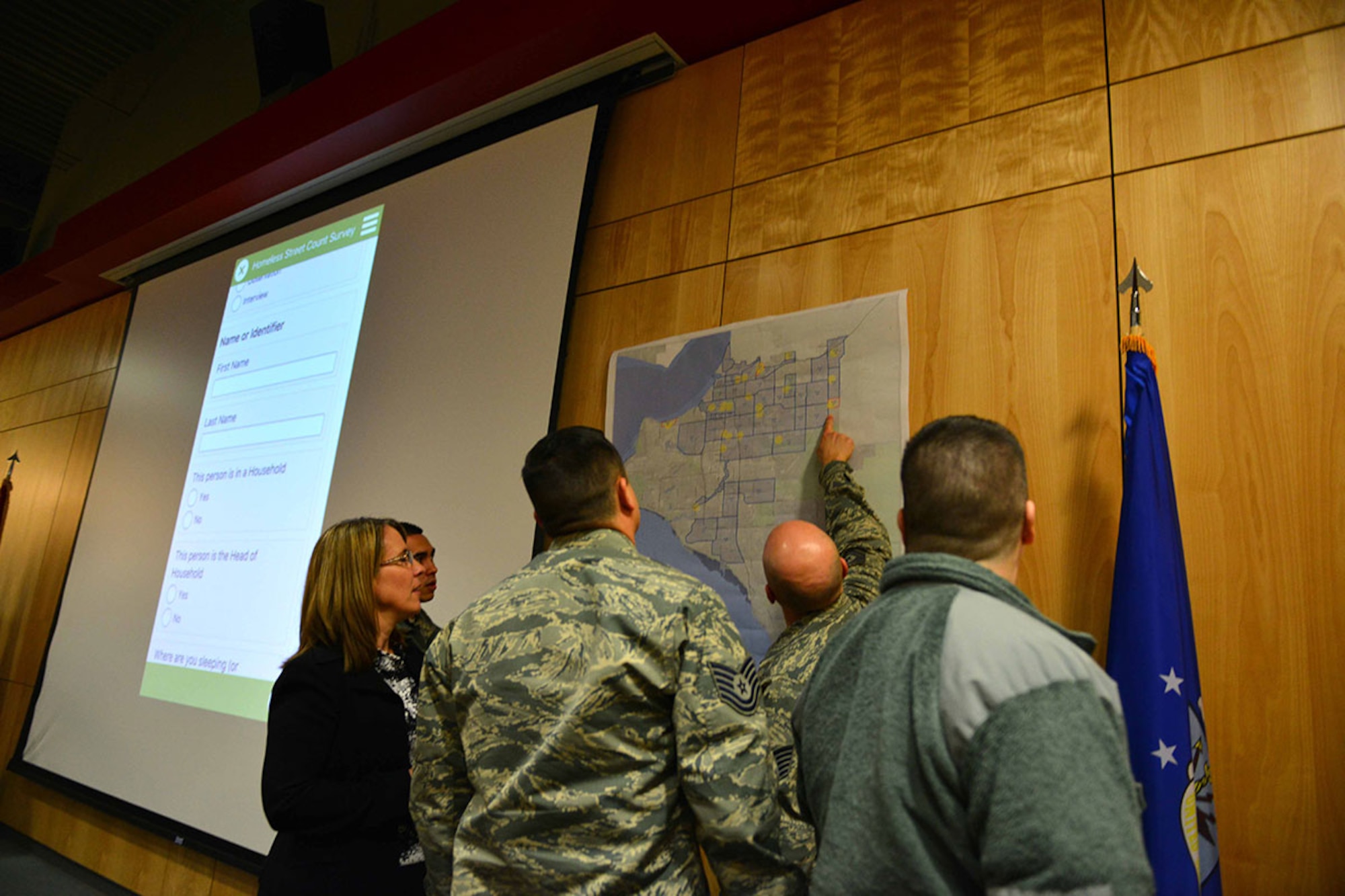 Airmen discuss which homeless communities they will survey during a briefing at the Elmendorf Professional Military Education Center, Jan. 21. During the training, Airmen received information on how to download the mobile application they would use to record data on the Anchorage homeless population and their medical needs. (U.S. Air Force photo by Airman 1st Class Kyle Johnson/Released)