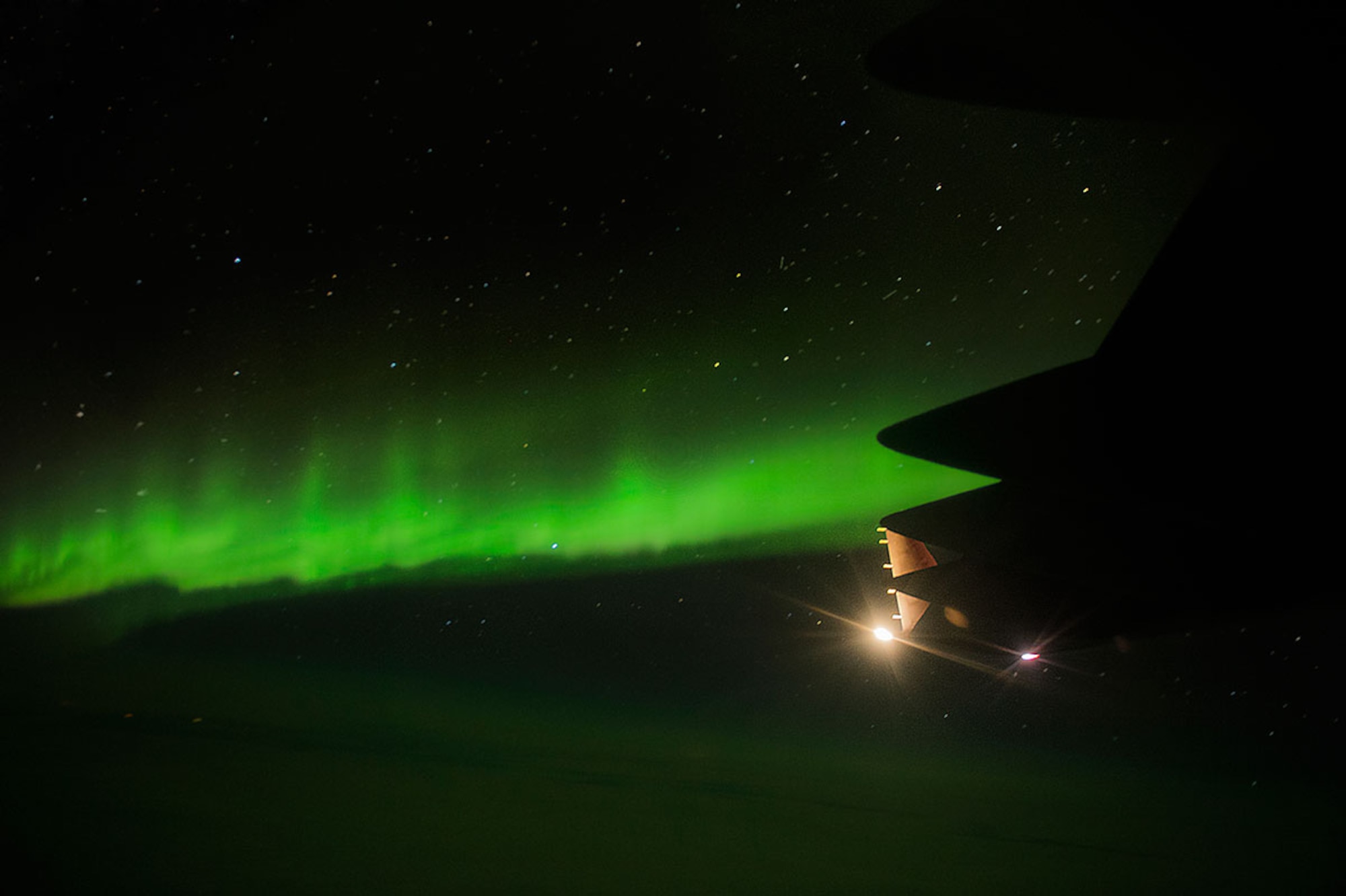 The aurora borealis is seen as a U.S. Air Force C-17 Globemaster III flies over Alaska during Operation Cobra Gold 2014, Jan. 13, 2014.   CG14  in its 33rd iteration, demonstrates the U.S. and the Kingdom of Thailand's commitment to their long-standing alliance and regional partnership, prosperity and security in the Asia-Pacific region.  (U.S. Air Force photo by Senior Airman James Richardson/ Released)