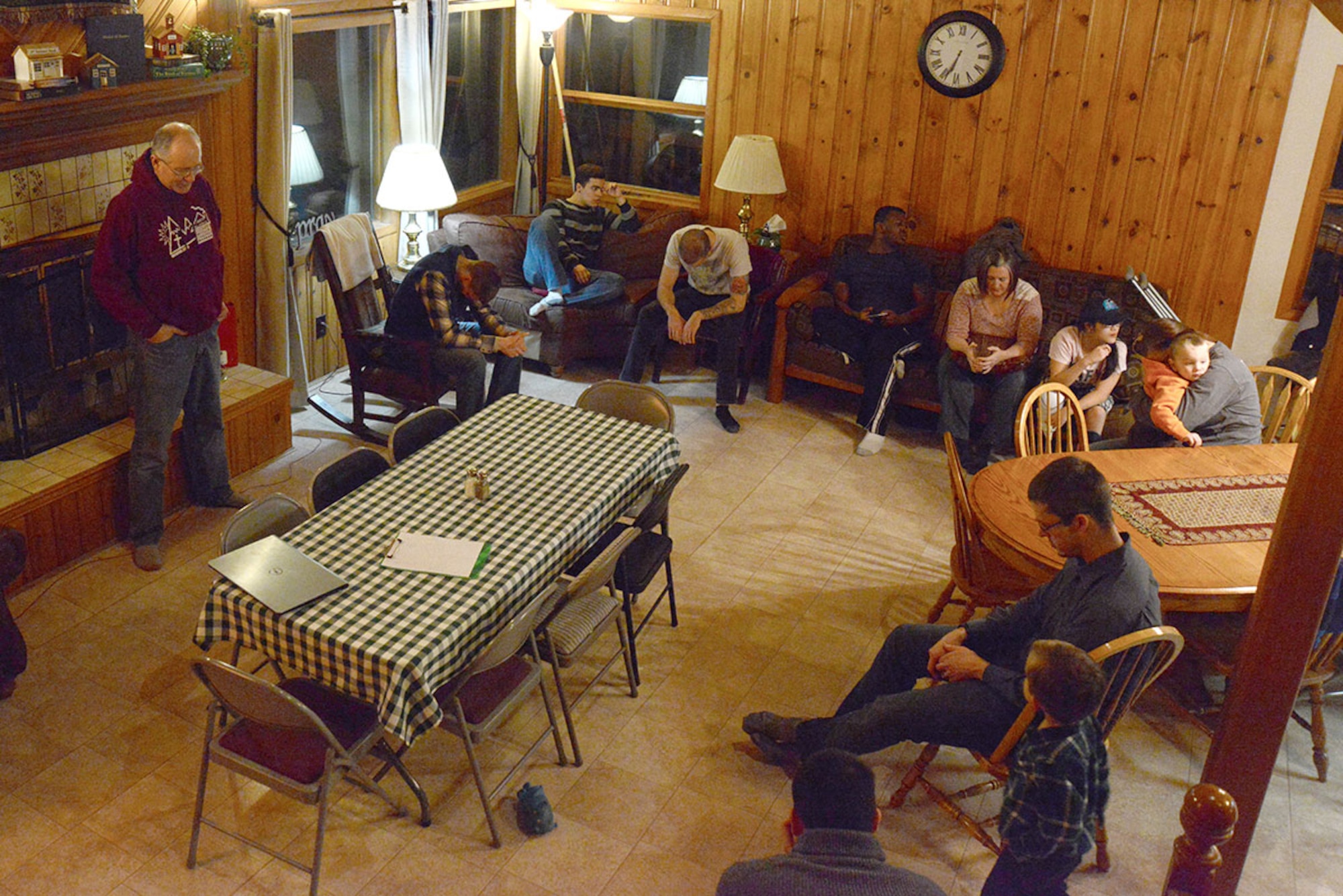 Mountain Chapel Hospitality House participants bow their head in prayer at Bob and Stephanie Caudle’s hospitality house in Eagle River, Alaska, Jan. 22, 2016. The MCHH manages the singles ministry for the Joint Base Elmendorf-Richardson Religious Operations Center where military members can build relationships with the community and God. (U.S. Air Force photo by Airman 1st Class Christopher R. Morales)