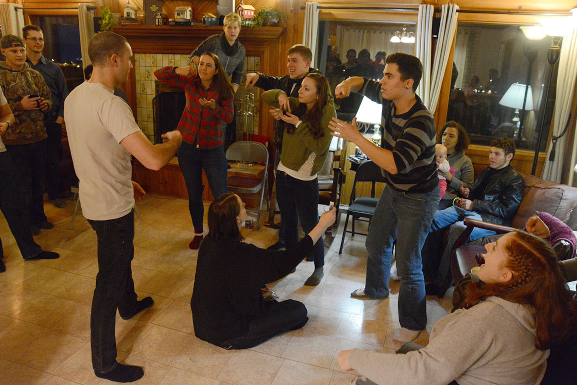Mountain Chapel Hospitality House participants play a team-based game of reverse-charades at Bob and Stephanie Caudle’s hospitality house in Eagle River, Alaska, Jan. 22, 2016. Games are played to break the ice with light-hearted competition. (U.S. Air Force photo by Airman 1st Class Christopher R. Morales)