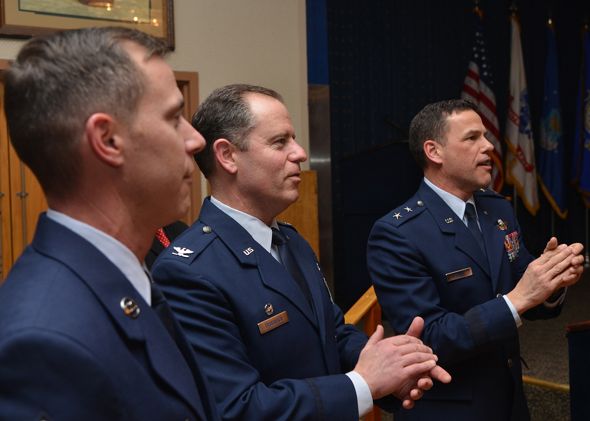 From left, Chief Master Sgt. Brion Blais, 377th Air Base Wing command chief, Col.
Eric Froehlich, 377th ABW commander, and Maj. Gen. Matthew Molloy, Air Force Operational Test and Evaluation Center commander, sing the Air Force song after induction of 54 honorary commanders Jan. 29 at the Mountain View Club. (Photo by Todd Berenger)