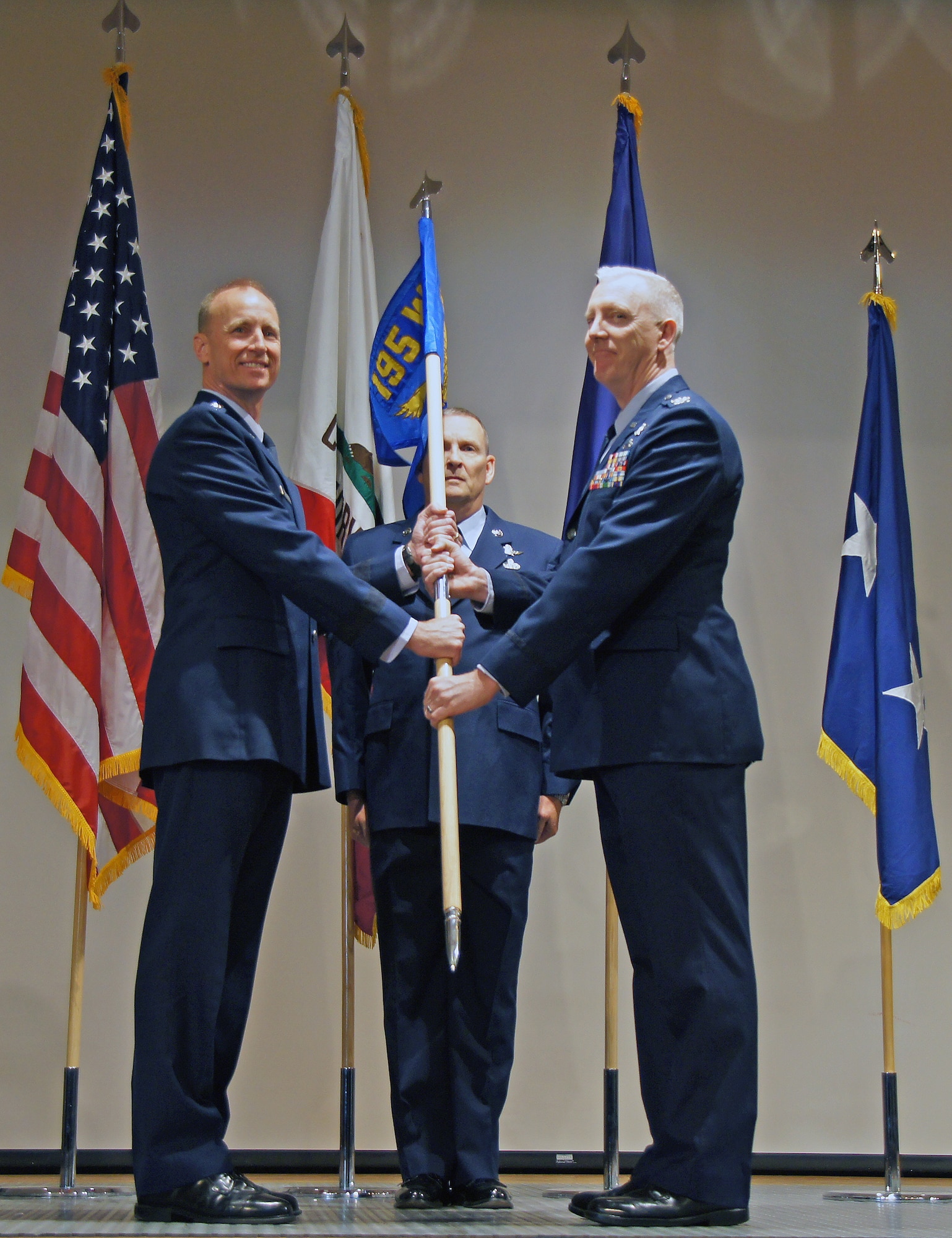 California Air National Guard Commander Maj. Gen. Jon Kelk, left, Chief Master Sgt. James Raff and 195th Wing Commander Col. Rick Hern present the 195th Wing colors during an activation ceremony for the wing at Beale Air Force Base, Calif., Nov. 7. (California National Guard photo by Spc. Sigmund Rakiec)