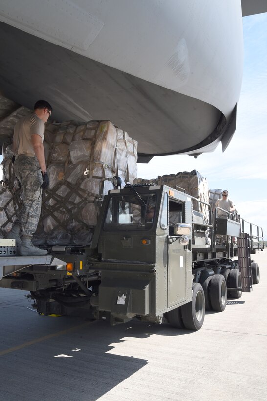 From left, 1st Lt. Jose Marrero, Staff Sgt. Jordan Woodard and Staff Sgt. Jesus Vasquez, 612th Air Base Squadron members, make sure that a load of cargo is secured at Soto Cano Air Base, Honduras, Feb. 2, 2016. The cargo is part of the Denton cargo donation program and will be to a storage location until the nongovernmental organization responsible for delivering it to the local community can come to retrieve it. (U.S. Army photo by Martin Chahin)