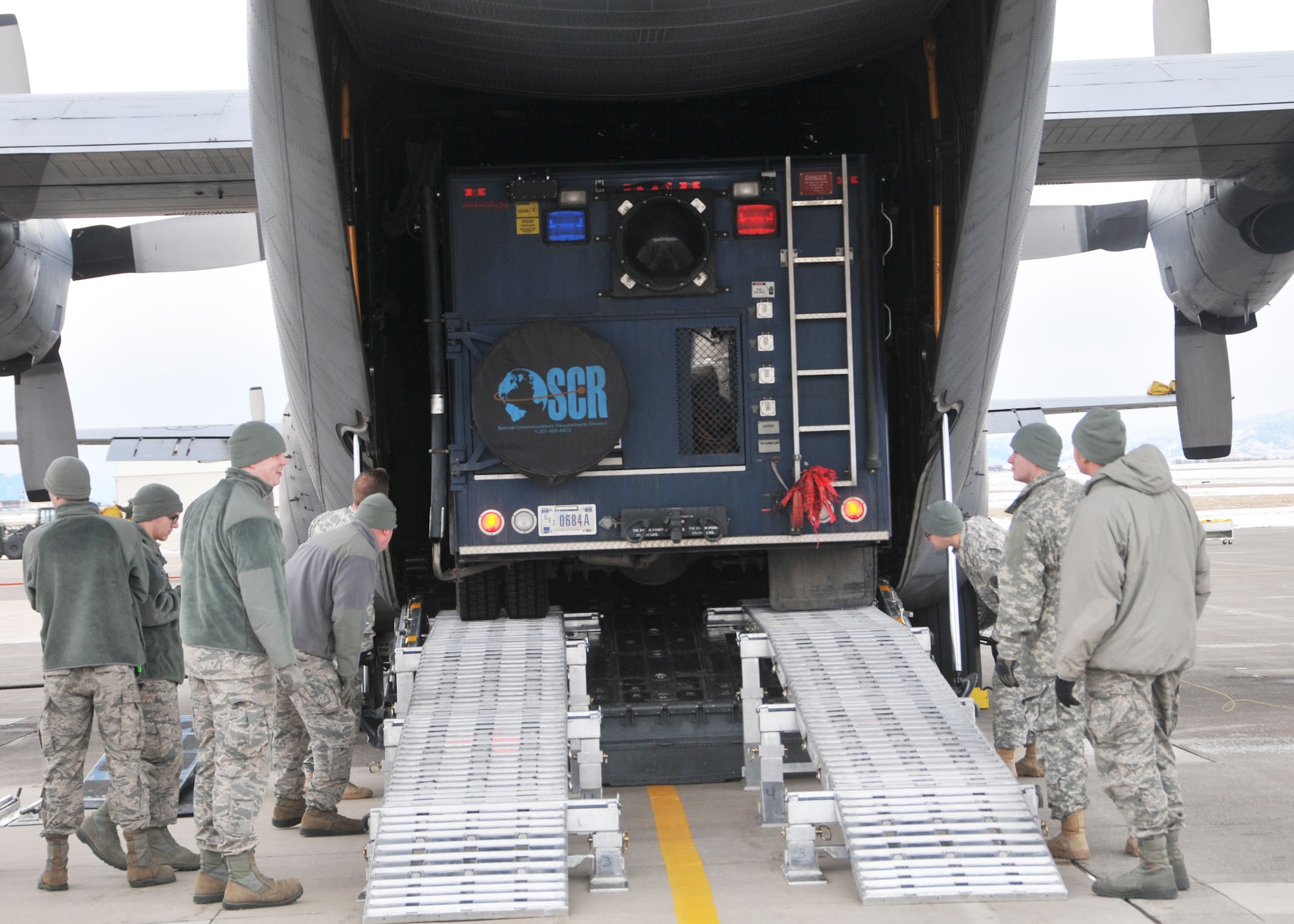 Members of the 83rd Civil Support Team and 120th Airlift Wing of the Montana National Guard load a CST operations vehicle onto a C-130 Hercules Jan. 21, 2016. The guardsmen were exercising the loading of CST equipment and vehicles should they have to transport the equipment in an actual state or federal emergency. (U.S. Air National Guard photo by Senior Master Sgt. Eric Peterson/Released)
