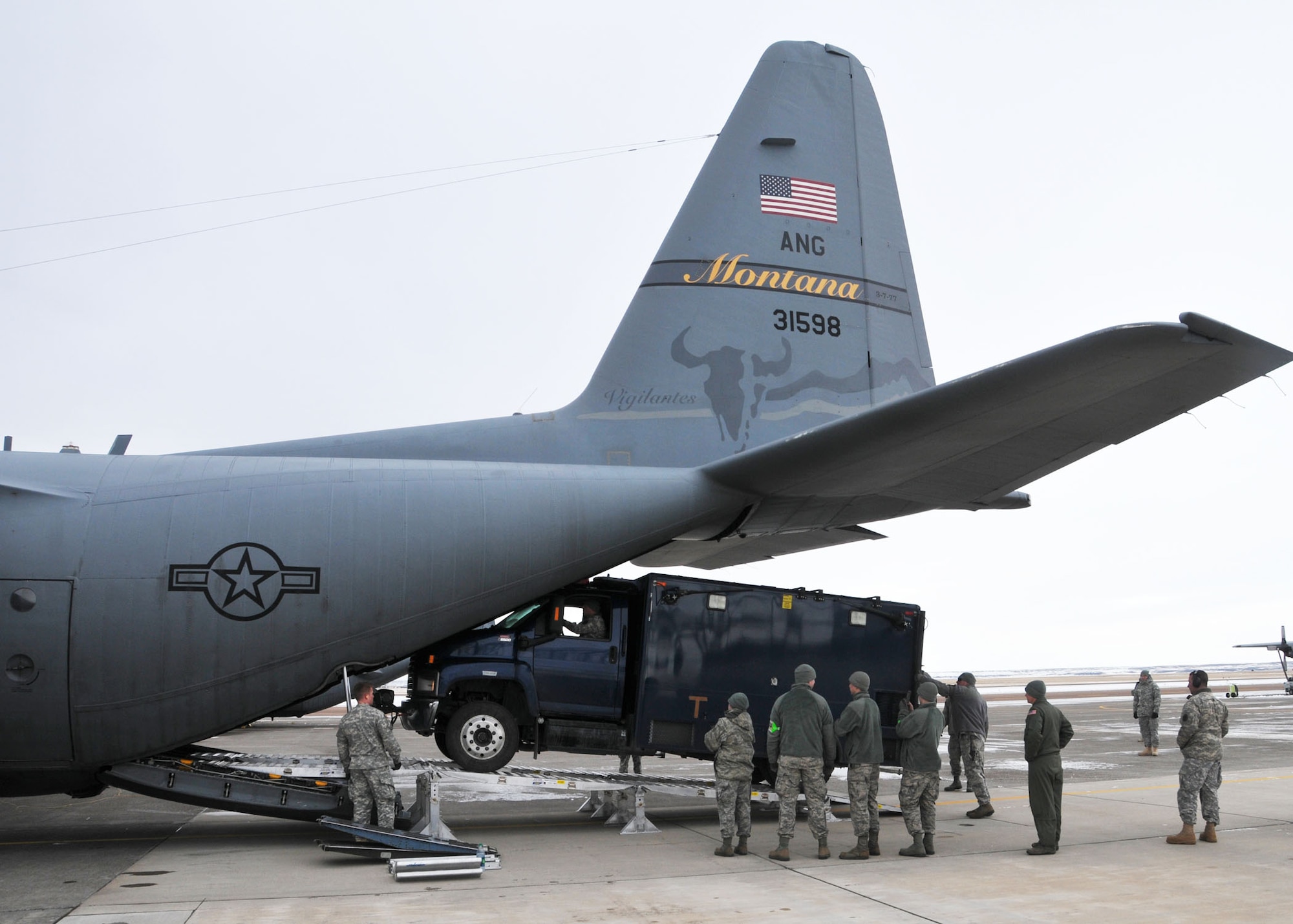 Members of the 83rd Civil Support Team and 120th Airlift Wing of the Montana National Guard load a CST operations vehicle onto a C-130 Hercules Jan. 21, 2016. The guardsmen were exercising the loading of CST equipment and vehicles in the event they have to transport the equipment in an actual state or federal emergency. (U.S. Air National Guard photo by Senior Master Sgt. Eric Peterson/Released) 