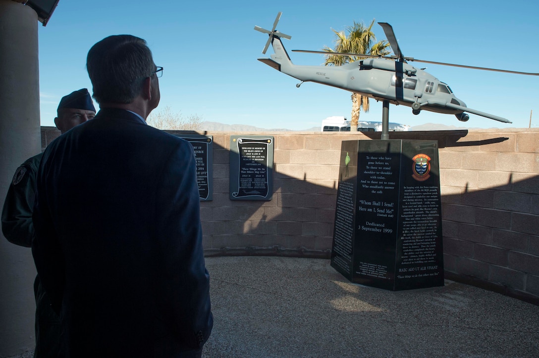 Defense Secretary Ash Carter observes a memorial for fallen airmen who were assigned to the 66th Rescue Squadron on Nellis Air Force Base, Nev., Feb. 4, 2016. DoD photo by Navy Petty Officer 1st Class Tim D. Godbee
