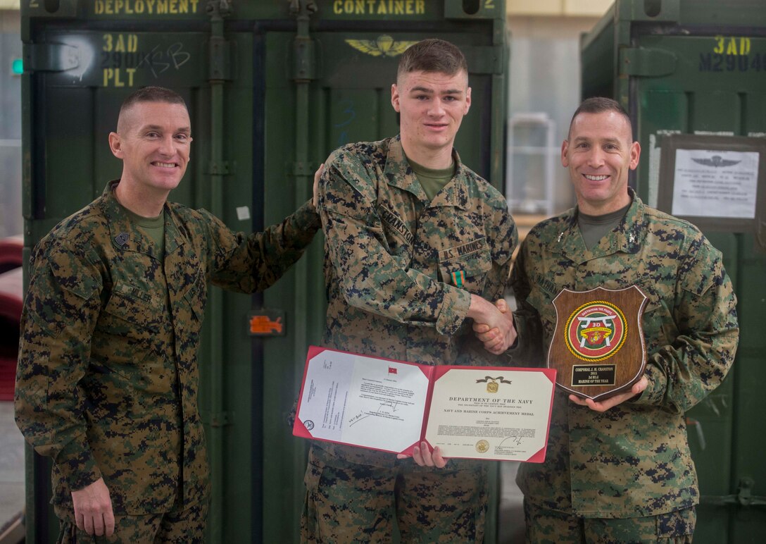 Cpl. John M. Cranston, middle, poses for a photo with Col. David Nathanson, right, and Sgt. Maj. Michael Miller, left, after receiving the 3rd Marine Logistics Group Marine of the Year award at Camp Foster, Okinawa, Japan, Feb. 5, 2016. Cranston was awarded Marine of the year for his devotion to his job and his commitment to being the best Marine he could be. Cranston from, Canby, Oregon, is an administrative specialist with 3rd Transport Support Battalion, Combat Logistics Regiment 3, 3rd MLG, III Marine Expeditionary Force. Nathanson from Jackson, New Jersey, is the commanding officer for CLR 3. Miller from French Camp, California, is the Sergeant Major of CLR 3. (U.S. Marine Corps Photo by Cpl. Devon Tindle/Released)