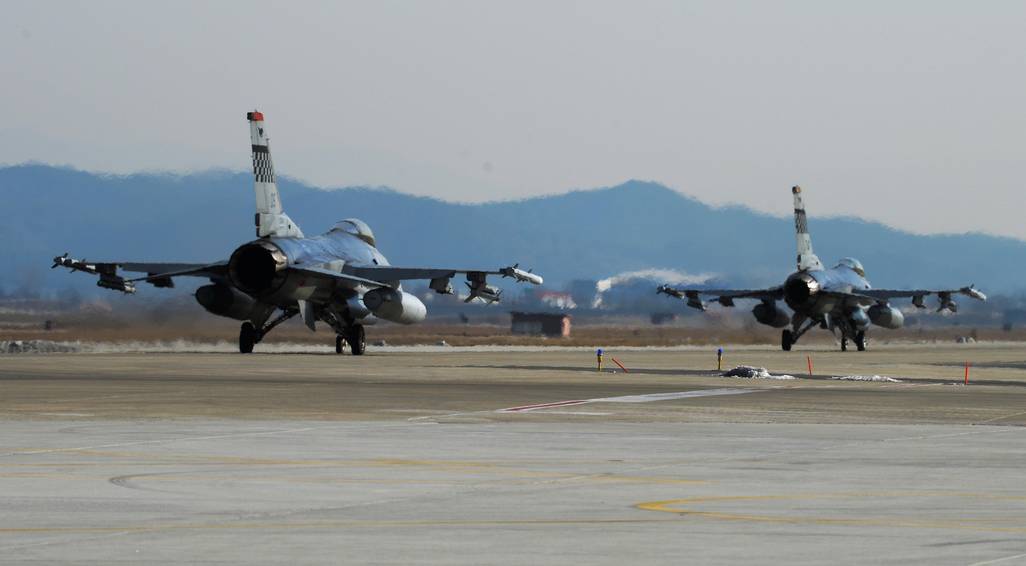 F-16 Fighting Falcons taxi before takeoff on the new runway at Osan Air Base, Republic of Korea, Jan. 22, 2016. The 51st Operations Support Squadron and 36th Fighter Squadron use the new runway to execute training and combat missions for the Republic of Korea. (U.S. Air Force photo by Airman 1st Class Dillian Bamman/Released)