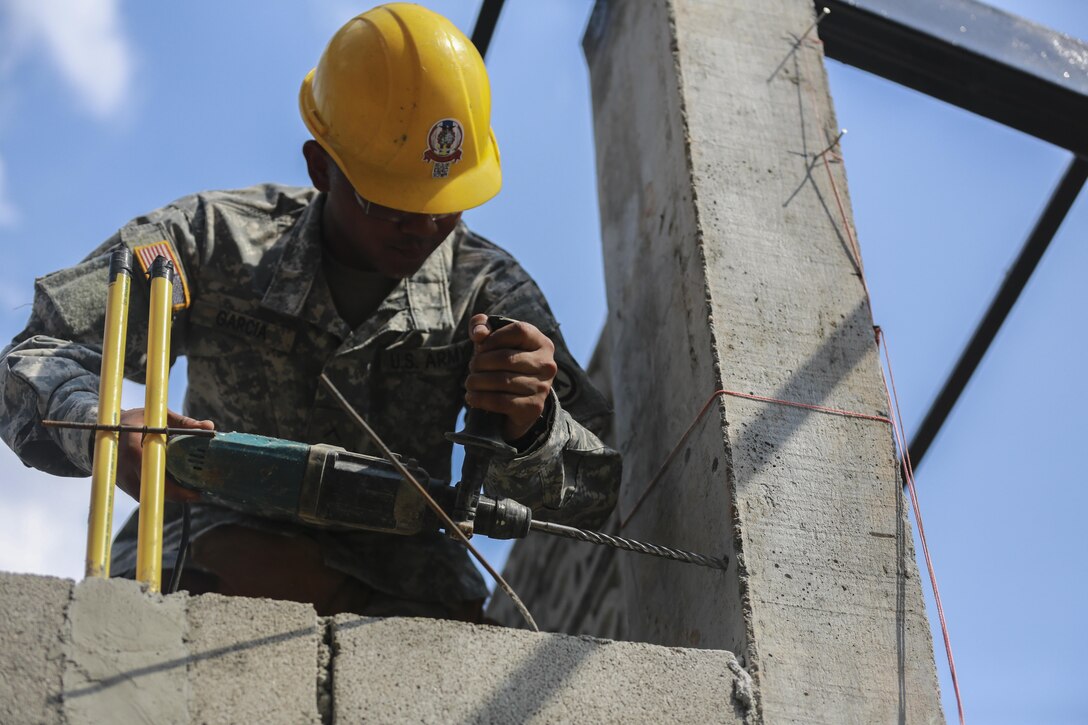 U.S. Army Pfc. James Garcia, carpenter and mason with 797th Engineer Company, Guam Army Reserve, drills into a support beam during the construction of a multi-purpose room at Ban Phrom Nimit School in Wang Yeng Nam, Thailand, during exercise Cobra Gold, Feb. 1, 2016. Cobra Gold 2016, in its 35th iteration, includes a specific focus on humanitarian civic action, community engagement, and medical activities conducted during the exercise to support the needs and humanitarian interests of civilian populations around the region.