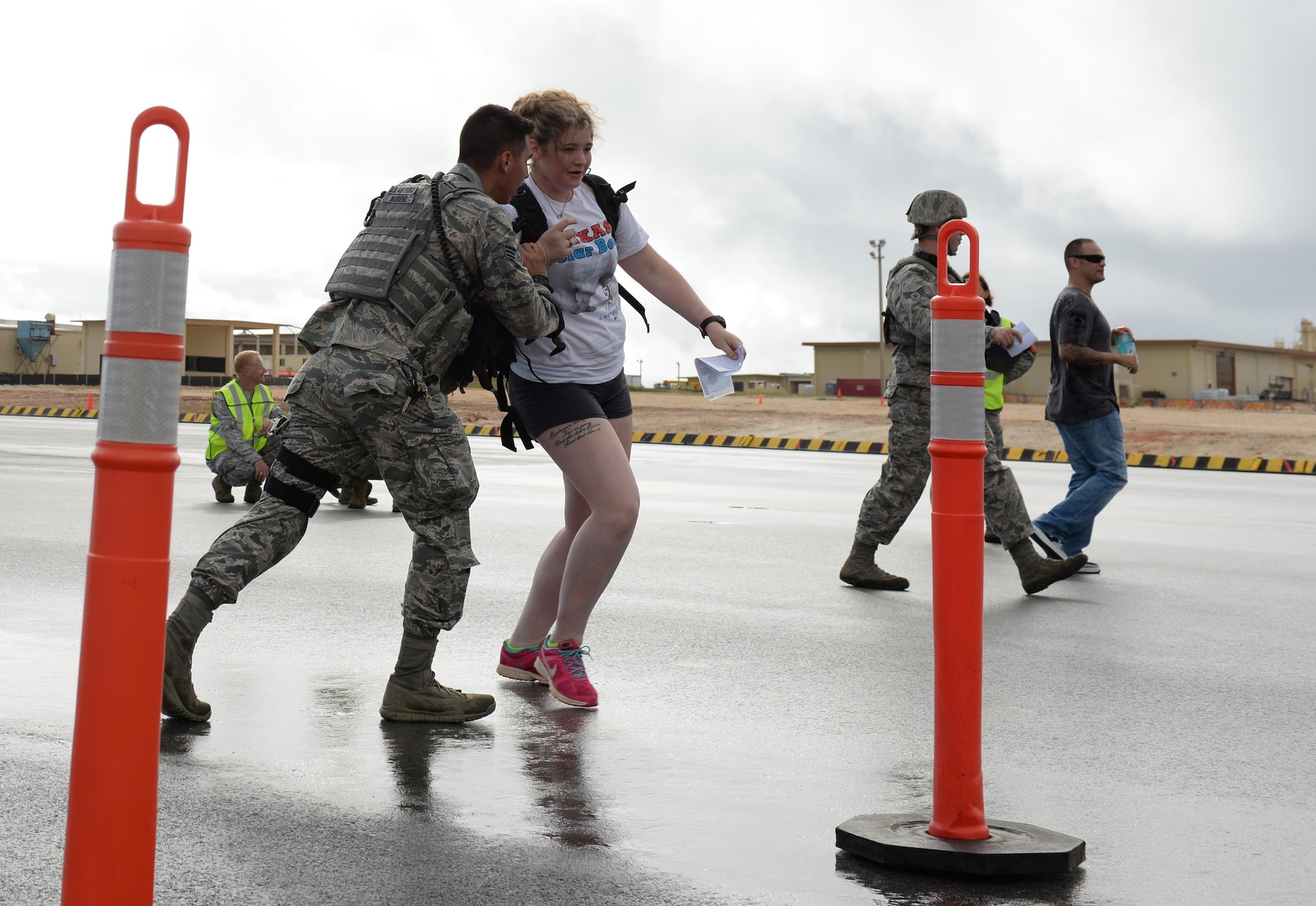 Senior Airman Nicholas Moreno, 36th Security Forces Squadron entry controller, directs an uninjured bystander to a secure location as part of a massive accident response exercise Feb. 3, 2016, at Andersen Air Force Base, Guam. This exercise tested Andersen AFB’s emergency readiness to prepare for the Pacific Air Partners Open House that is scheduled for Feb. 20. (U.S. Air Force photo/Airman 1st Class Jacob Skovo)